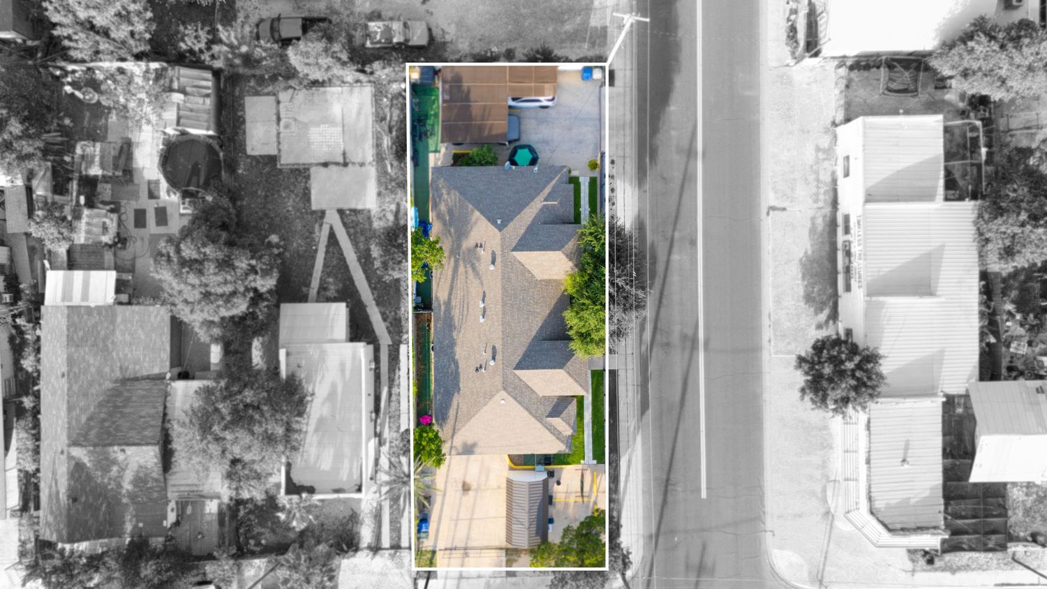 Aerial view of residential property with swimming pool and driveway shown in grayscale with teal and green accent markers.