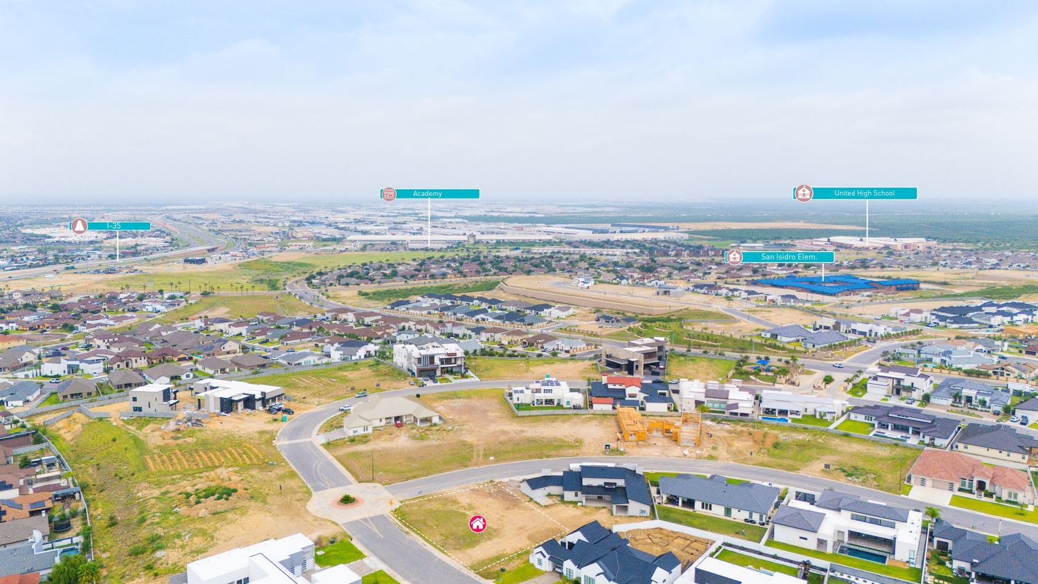 Aerial panoramic view of commercial warehouses and industrial buildings in a suburban business development area.