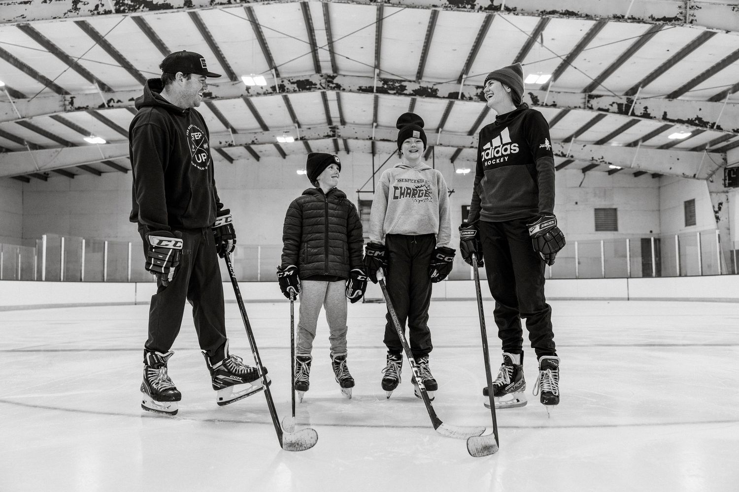 Black and white photo sequence showing ice hockey players skating and practicing drills on a rink.