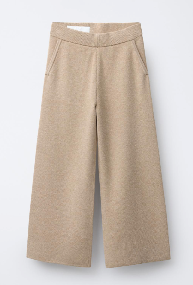 Beige knit cotton sweat shorts with elastic waistband shown from three different angles on white background.