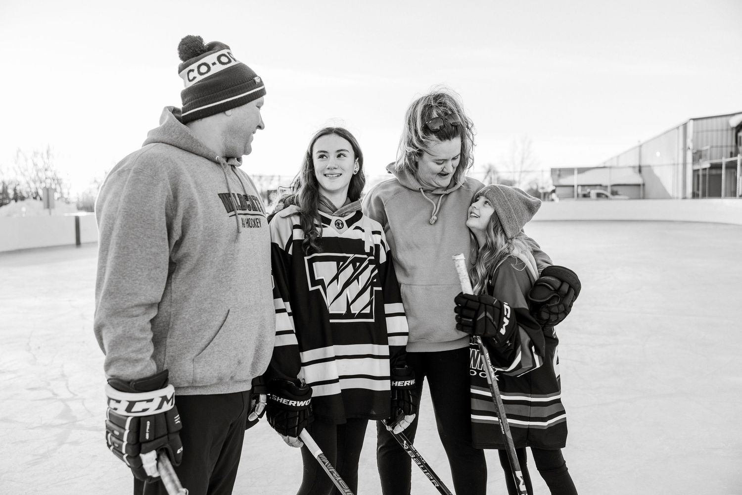 outdoor rink Saskatchewan childhood memories playing hockey as a family female hockey players candid hockey photos sask photographer
