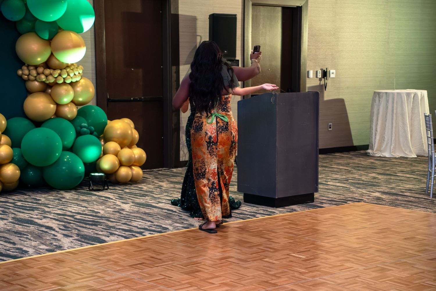A sequence of photos showing a balloon arch being assembled with green and gold balloons in a hotel hallway.