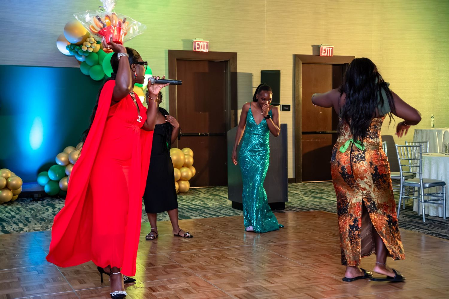 People dancing together in a colorful room with vibrant lighting and festive atmosphere.