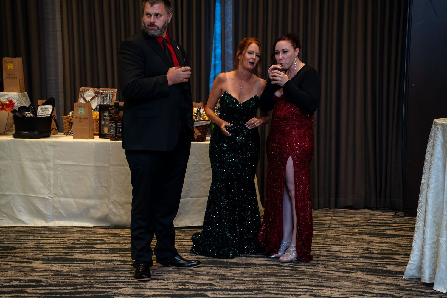 Wedding guests dance and celebrate together on a wooden dance floor at an elegant indoor reception.