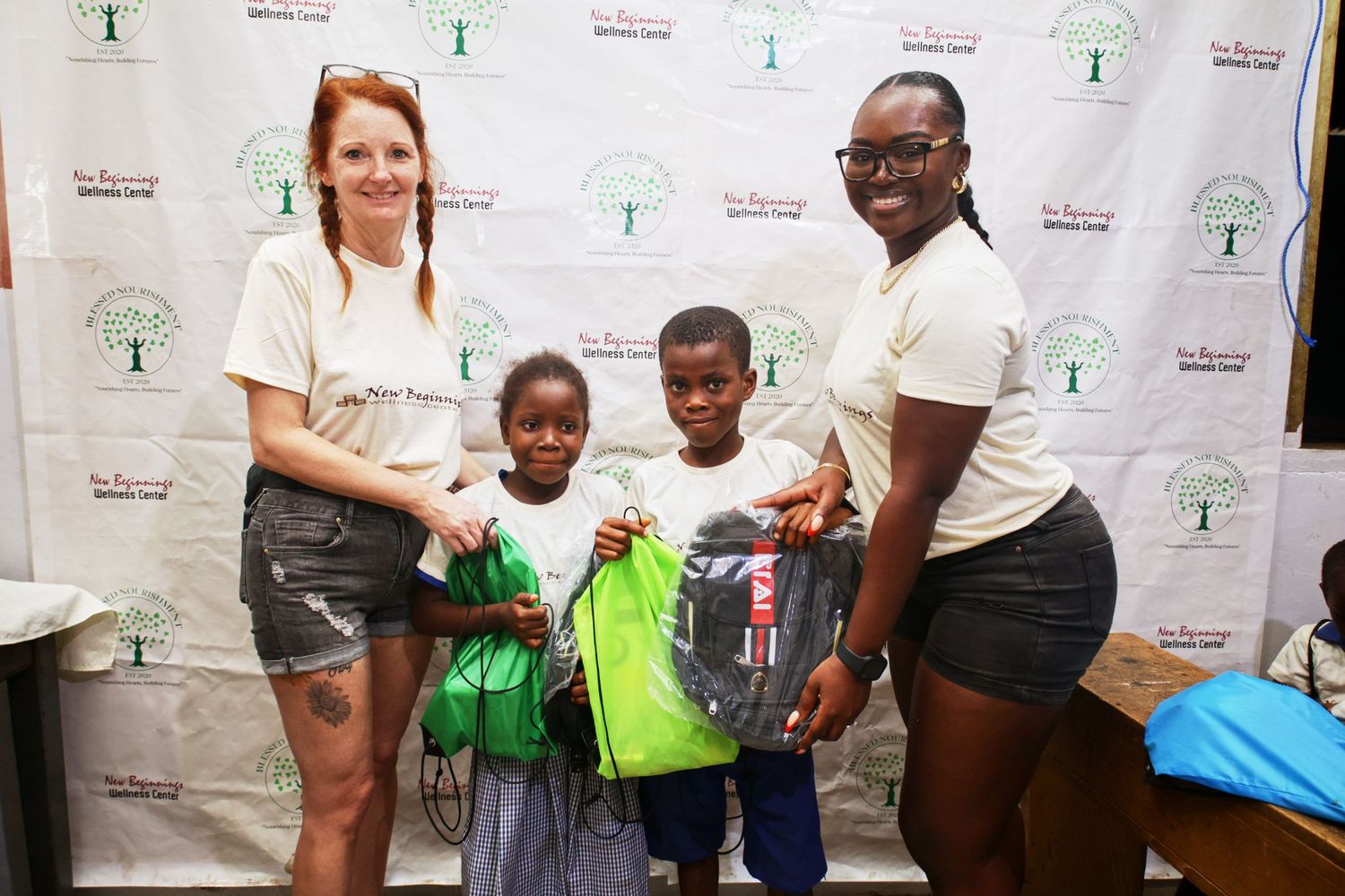 Group photo showing backpack distribution at a charitable event.