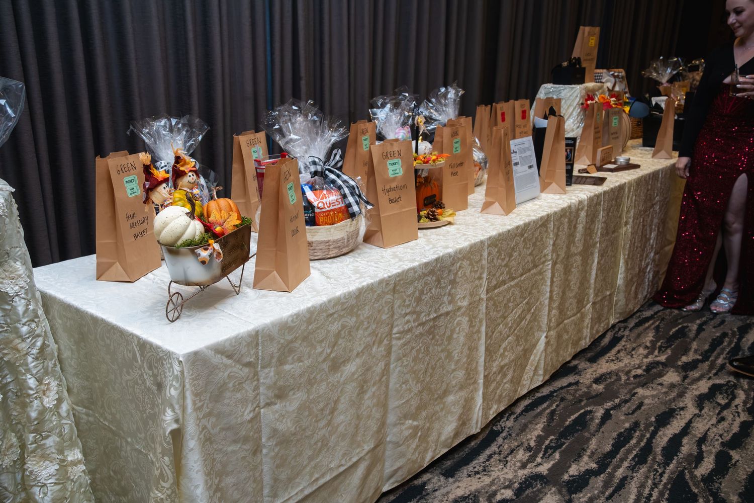 A long banquet table displays an elegant array of glassware and decorative items for a formal event or celebration.