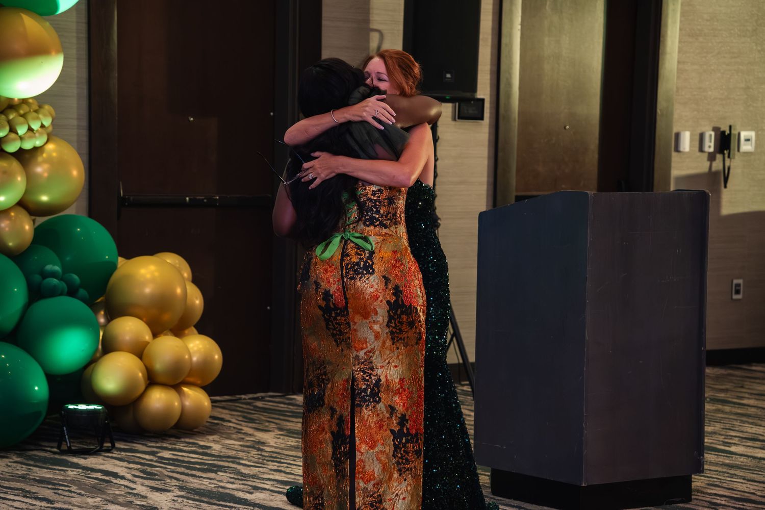 A sequence of photos showing a person in a floral dress walking past green and gold balloon decorations.