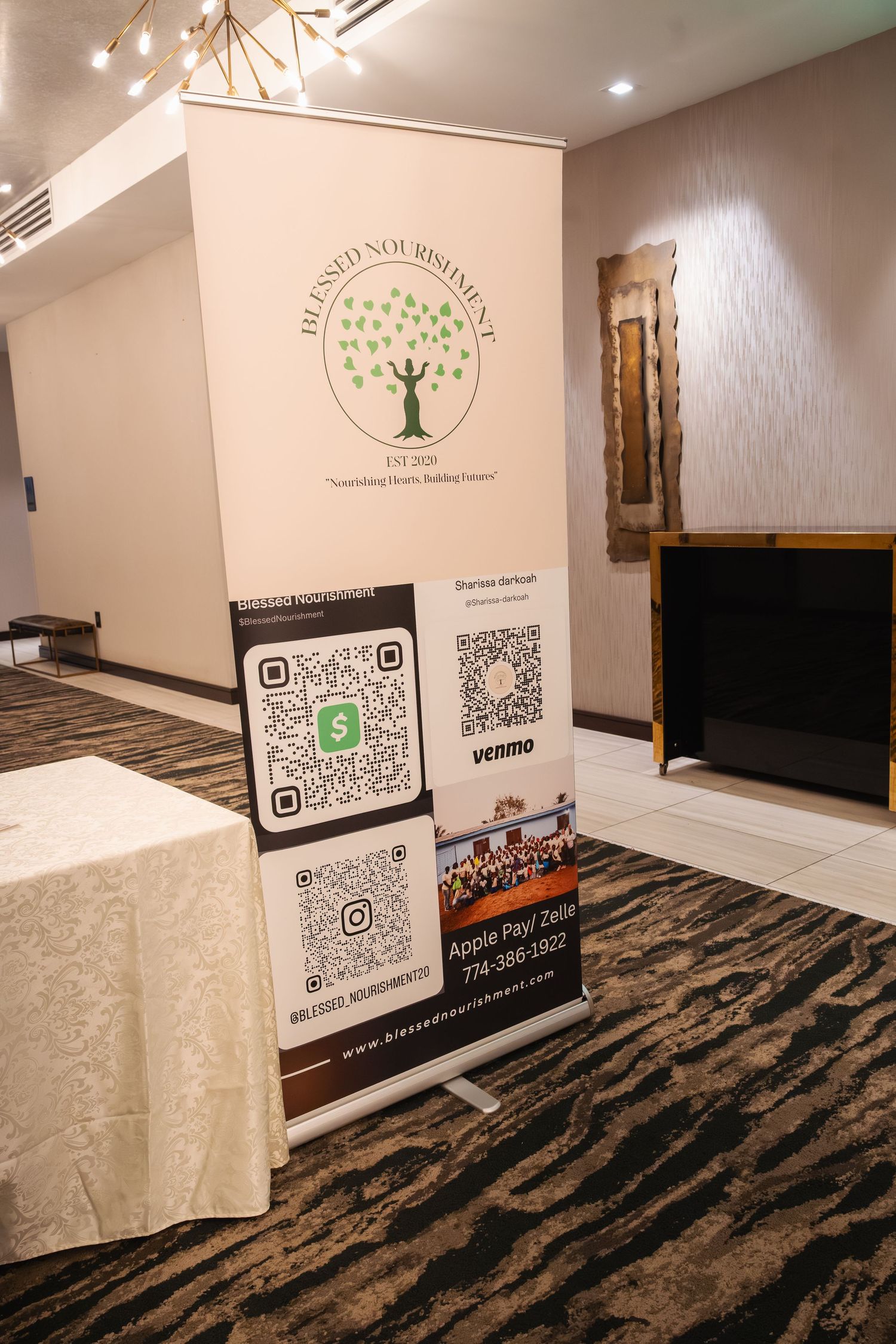 QR codes displayed on white walls and tables in a modern room with dark patterned carpeting.