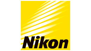 Nikon logo on yellow background with white diagonal lines and bold black text, representing the iconic camera and optics brand.