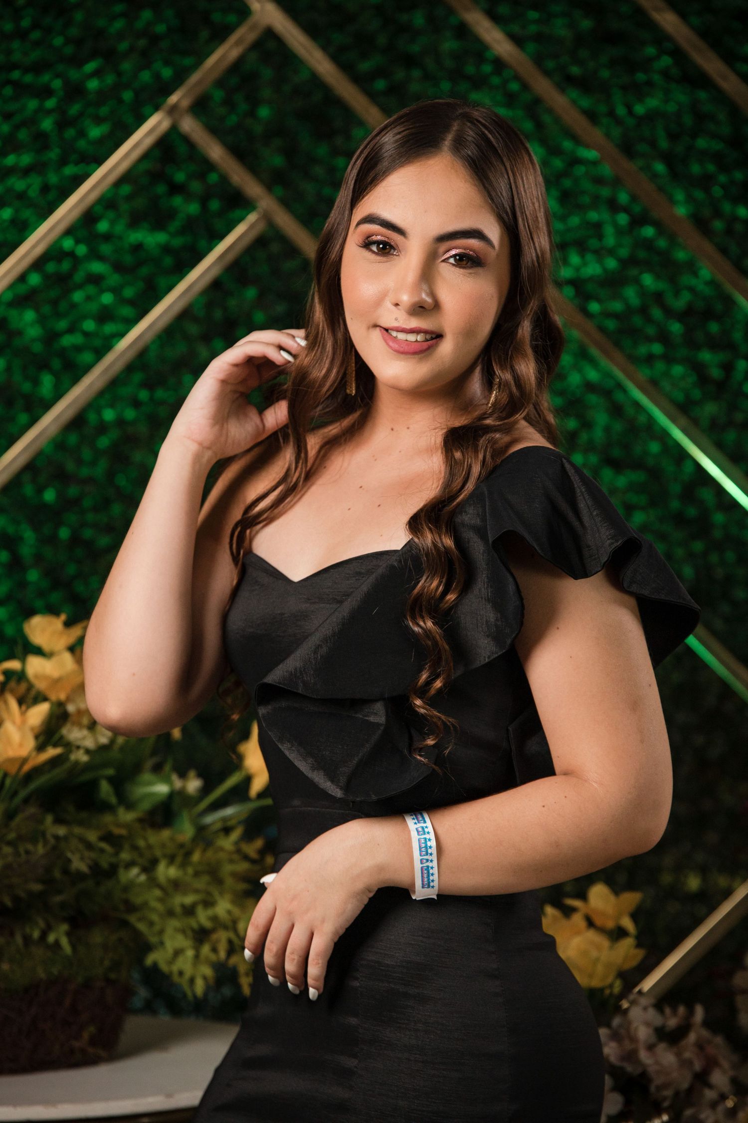 A series of portrait photos taken against a green hedge backdrop showing a person in an elegant black dress.