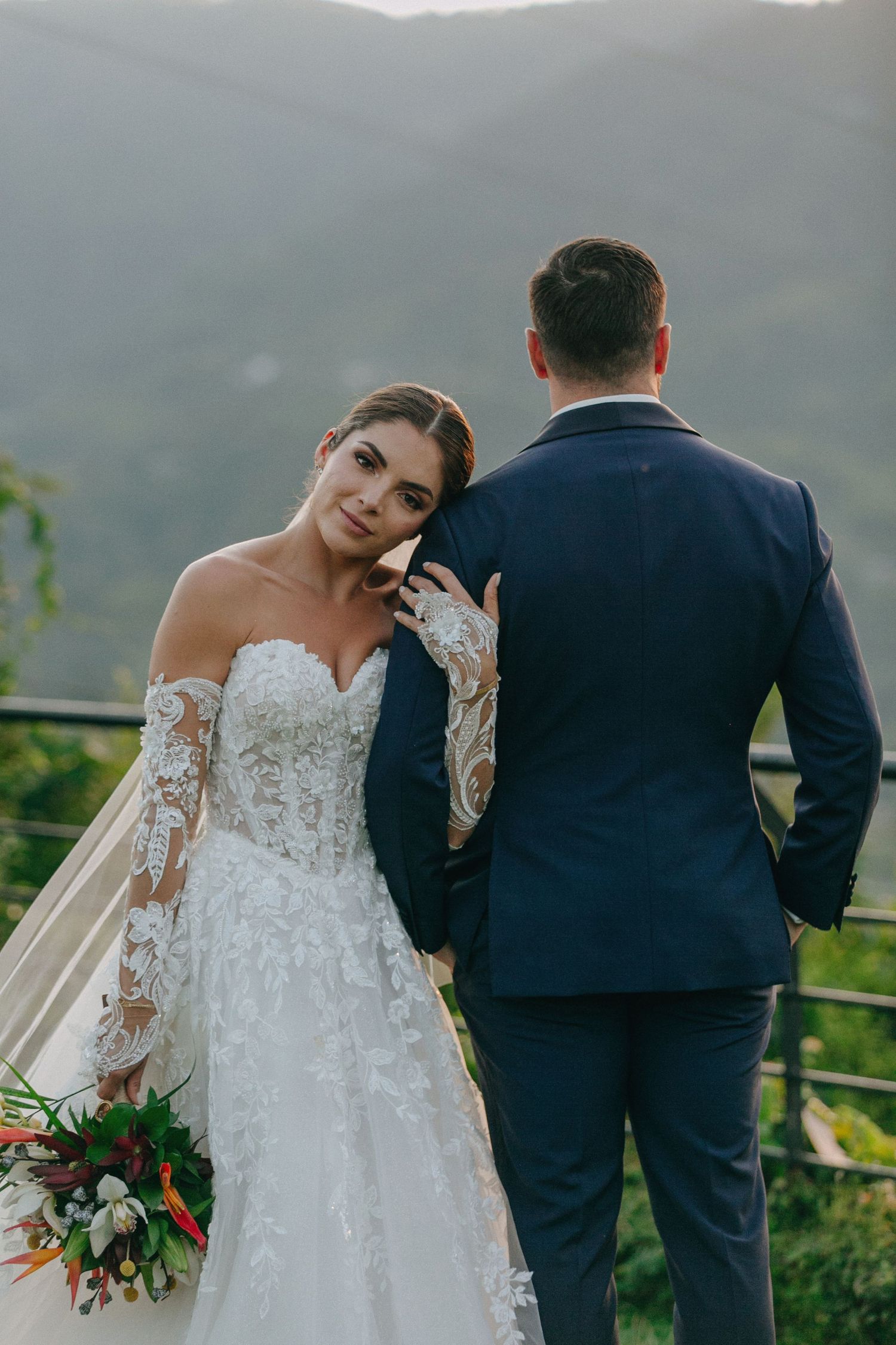 A romantic wedding photoshoot sequence showing a couple posing against a scenic mountain backdrop.