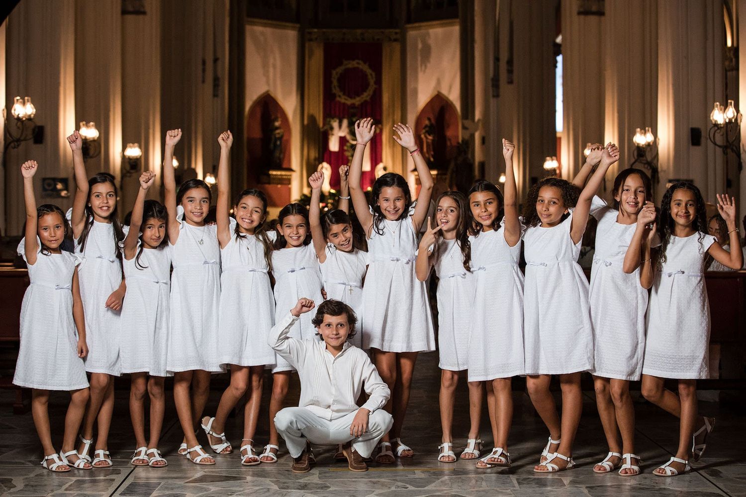 grupo de niñas y un niño en la iglesia celebrando primera comunion 2024
