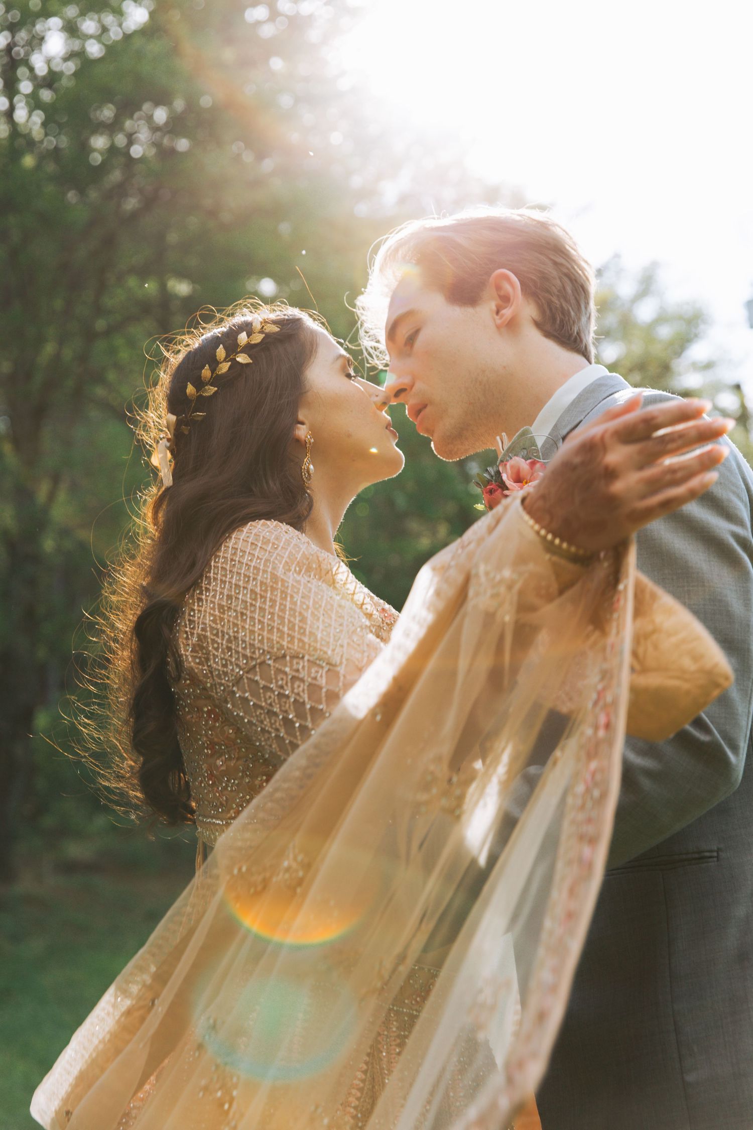 Bride and groom on wedding day, with bright sun shining down onto them.