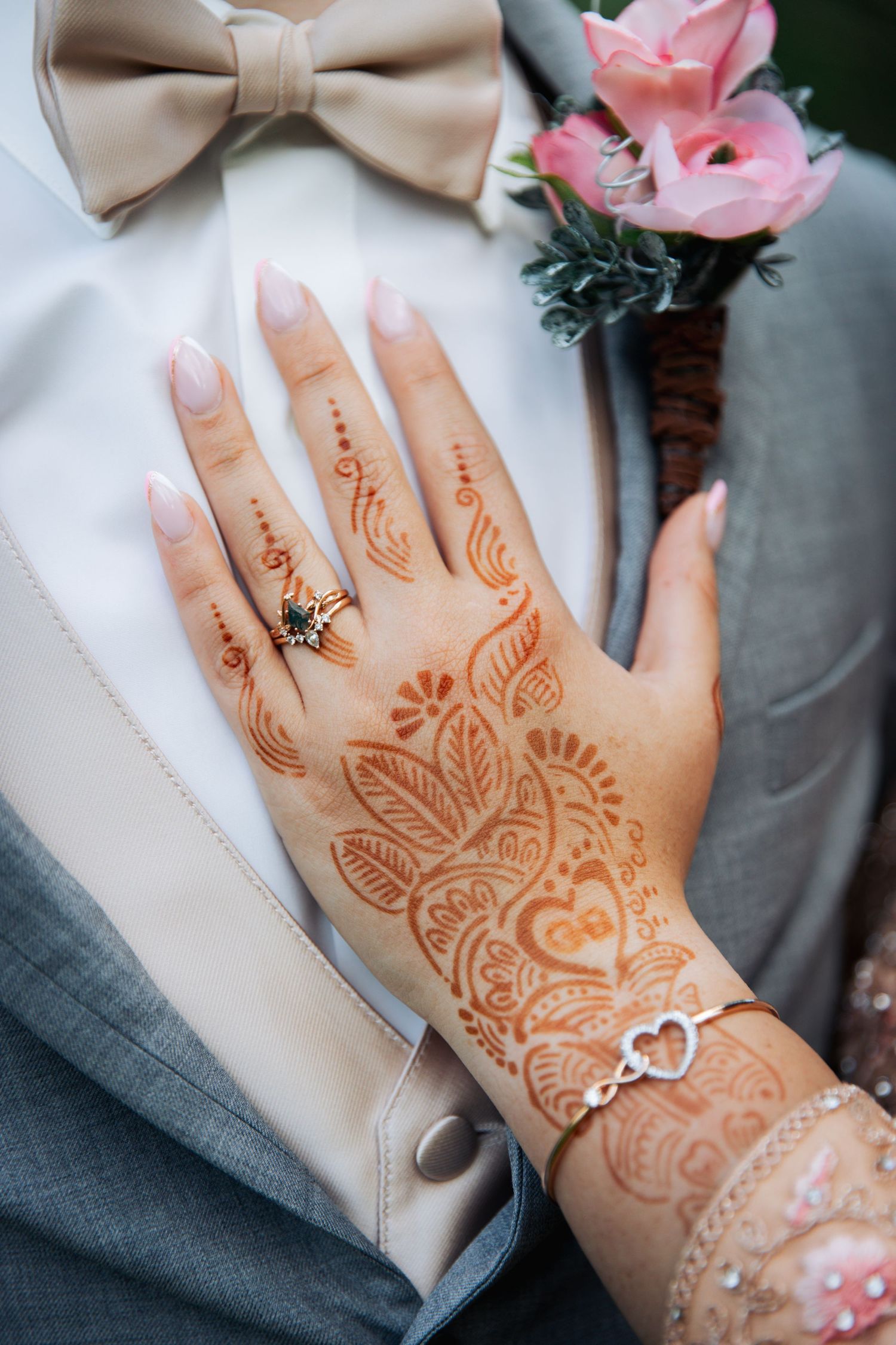 Bride's hand with henna, on groom's chest