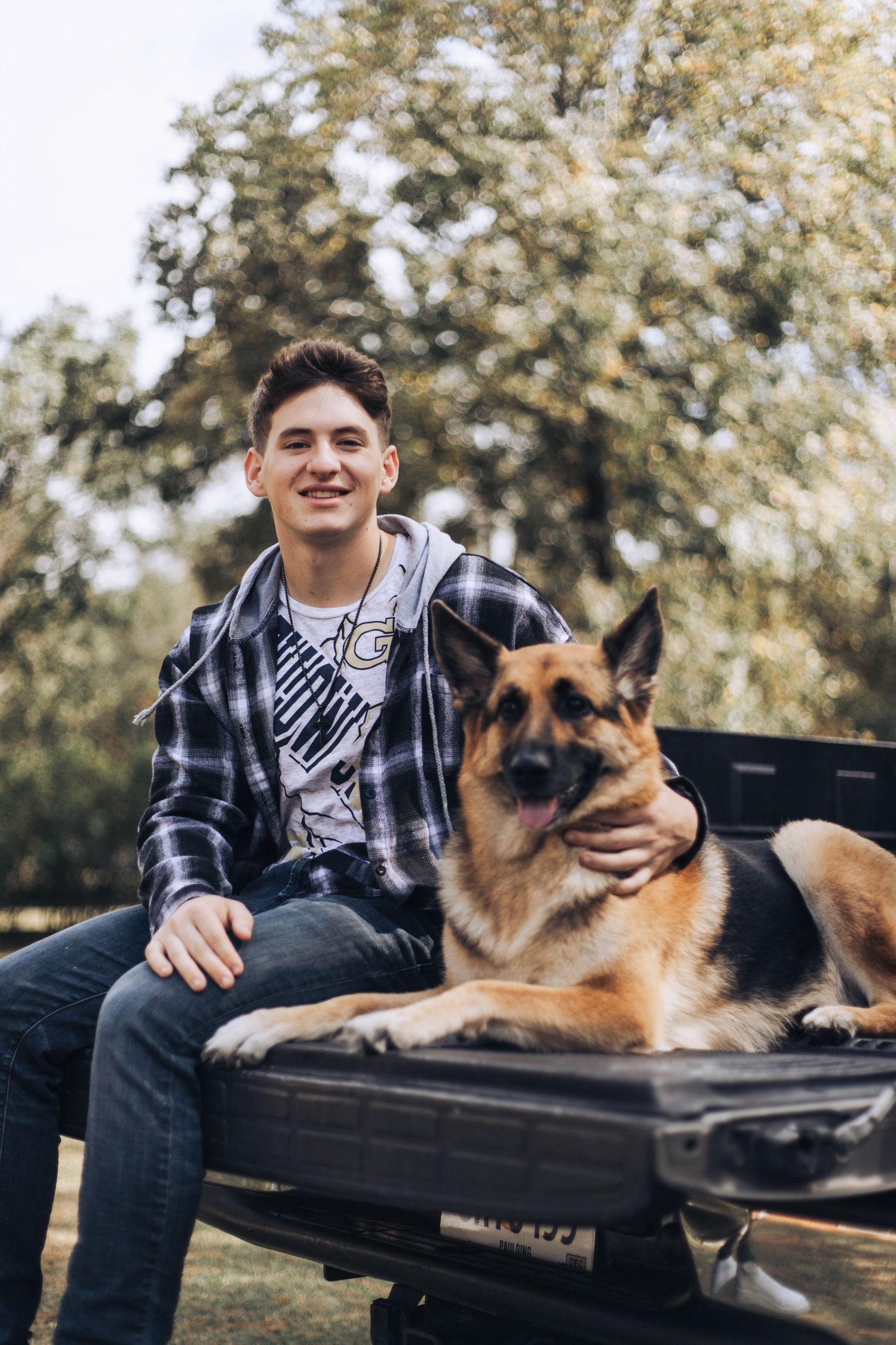 A series of outdoor photos showing someone relaxing on a bench with their German Shepherd dog.