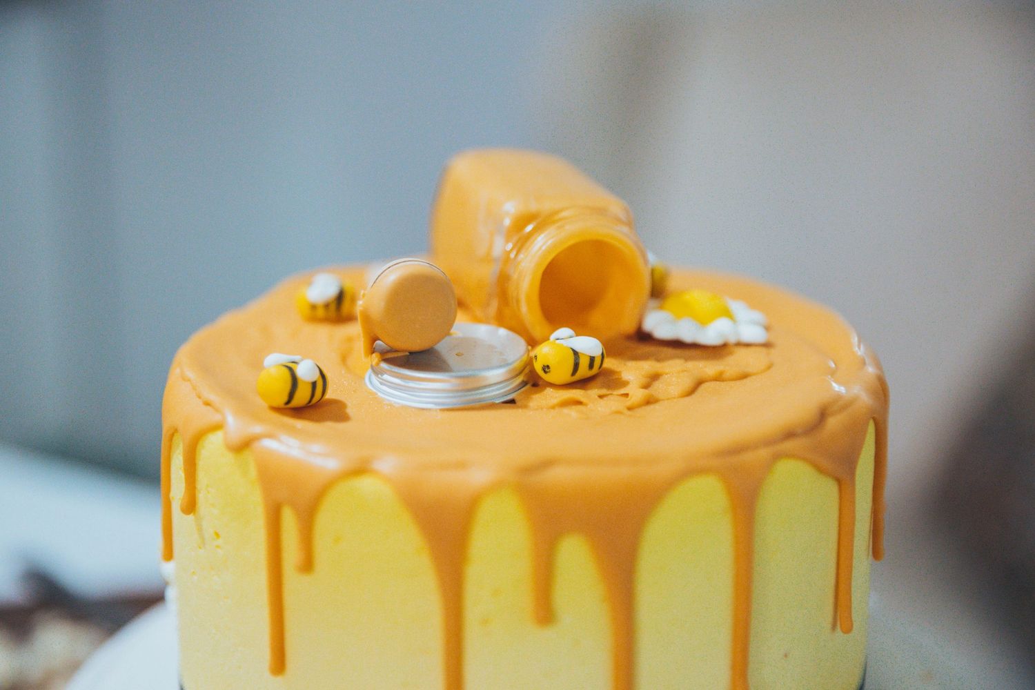 A layered cake with caramel drip frosting and gold decorative elements cascading down the sides.