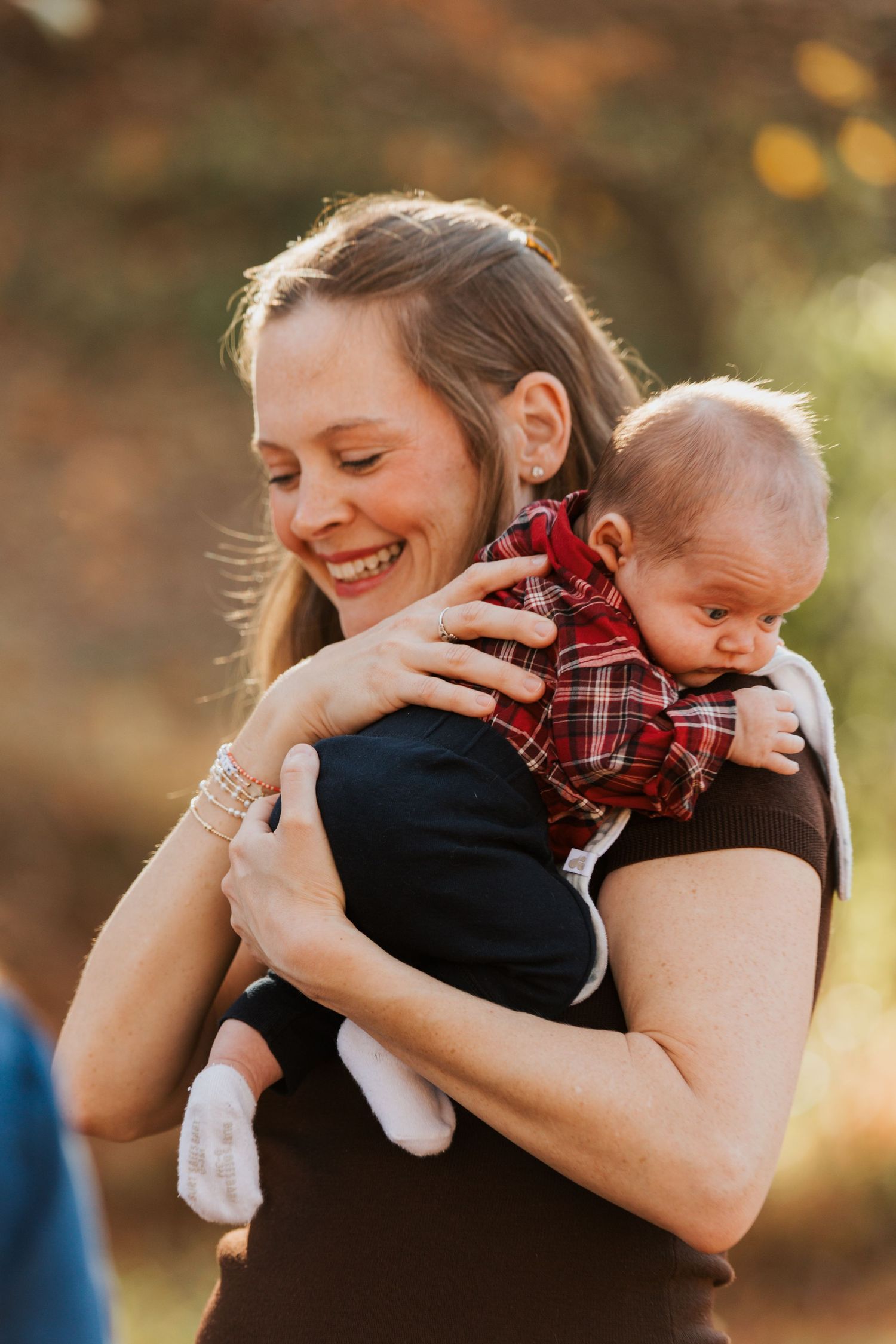 A series of tender moments captured between a parent and baby against a warm autumn backdrop.