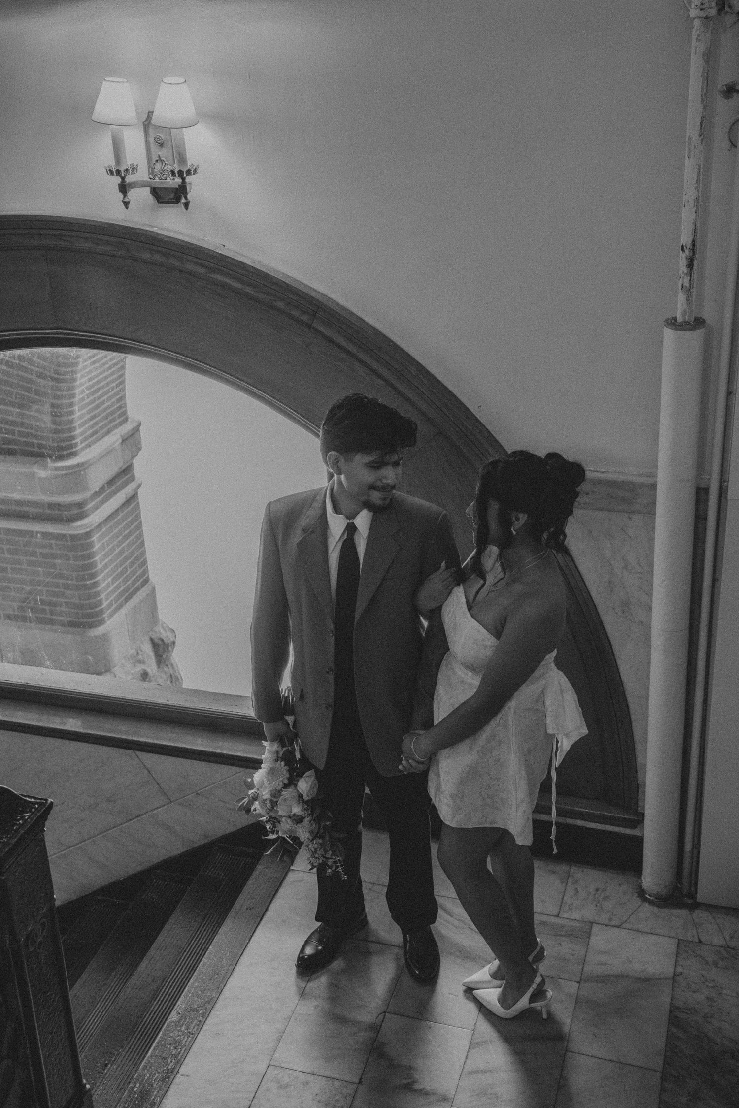 A black and white photo sequence shows two people in formal attire dancing together under an arched doorway.