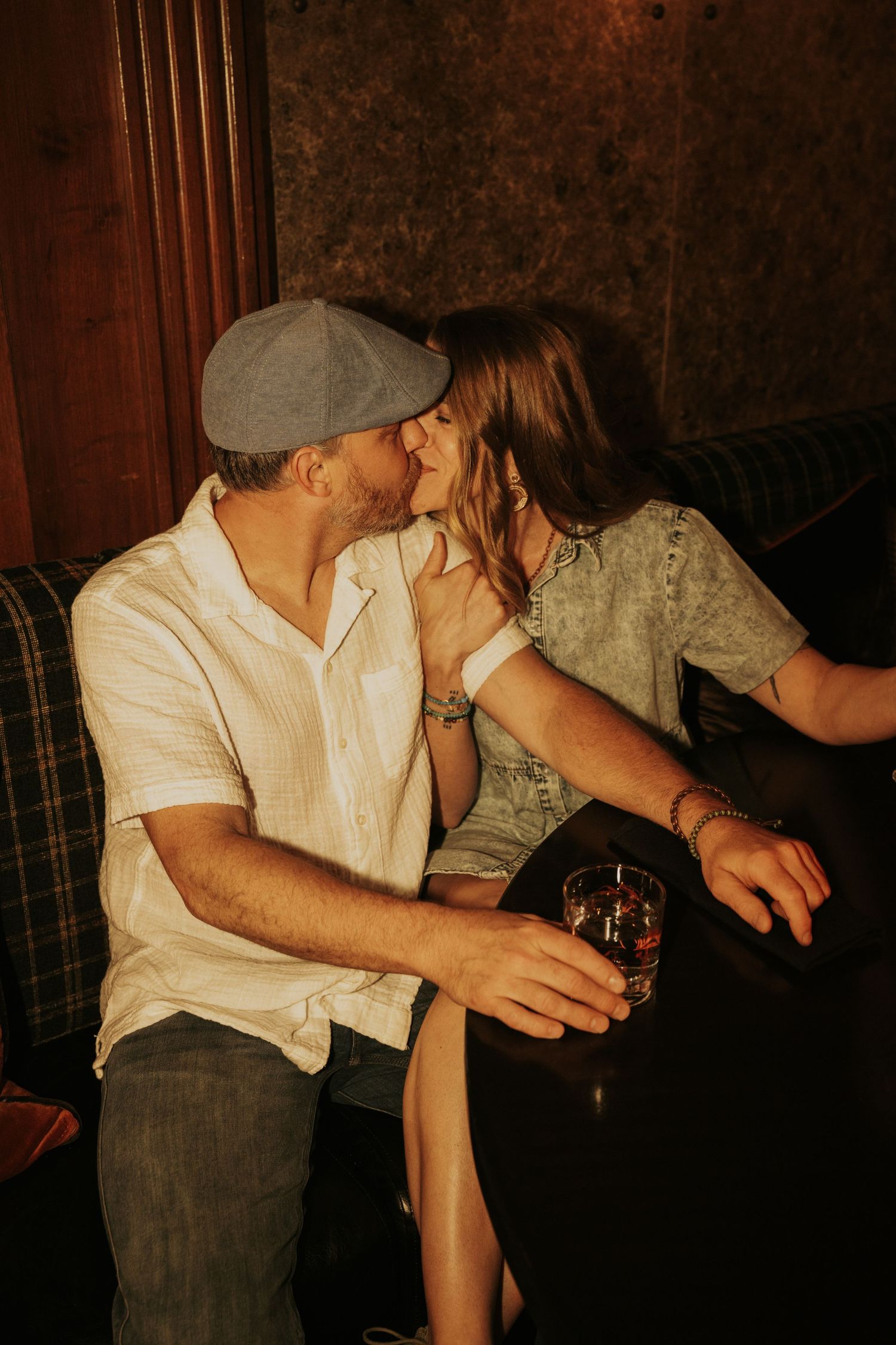 A sequence of dark moody photos showing hands holding drinks at a bar in dim lighting.