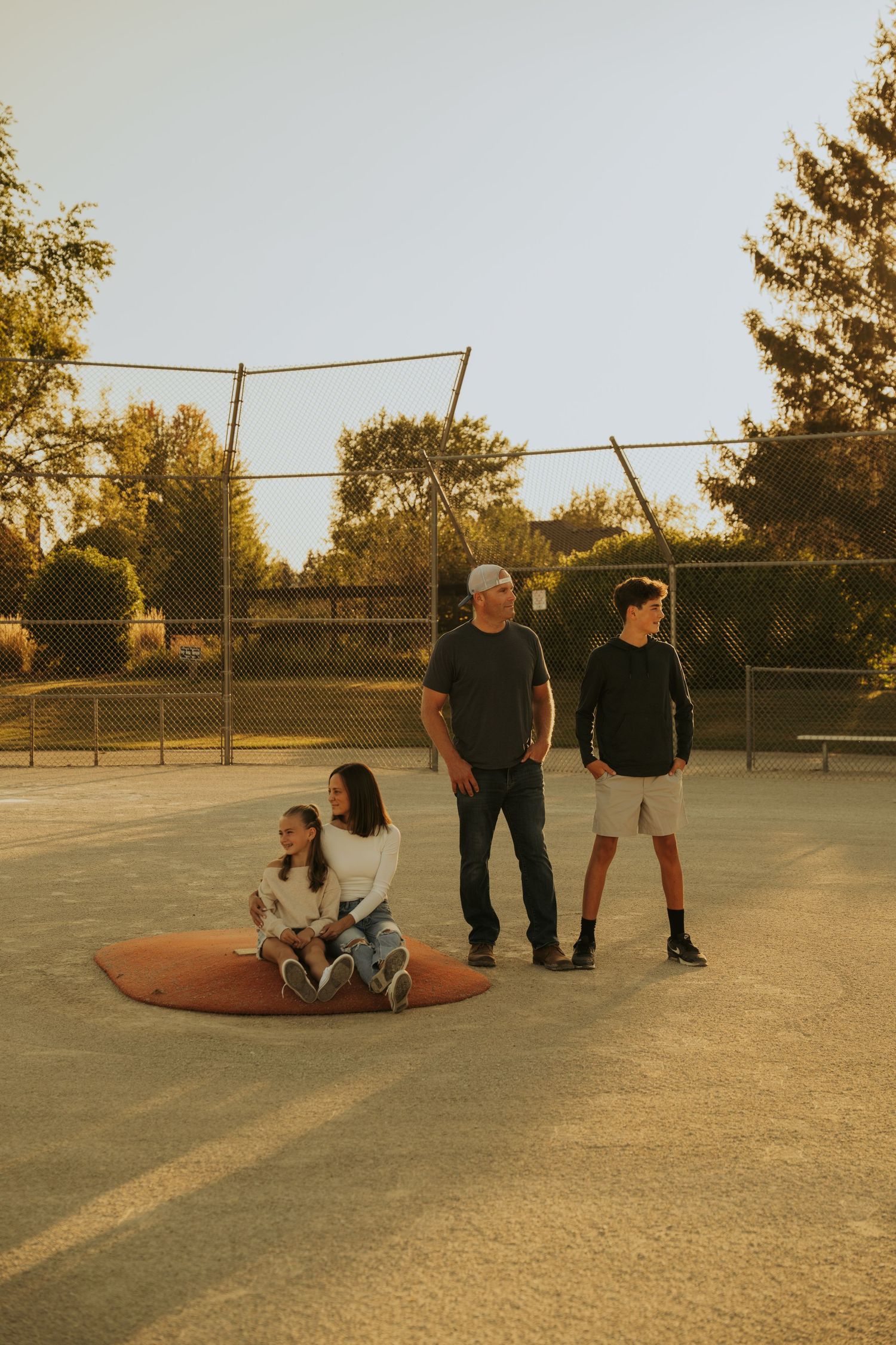 A sequence of skateboarding trick attempts at a skate park during golden hour sunset lighting.