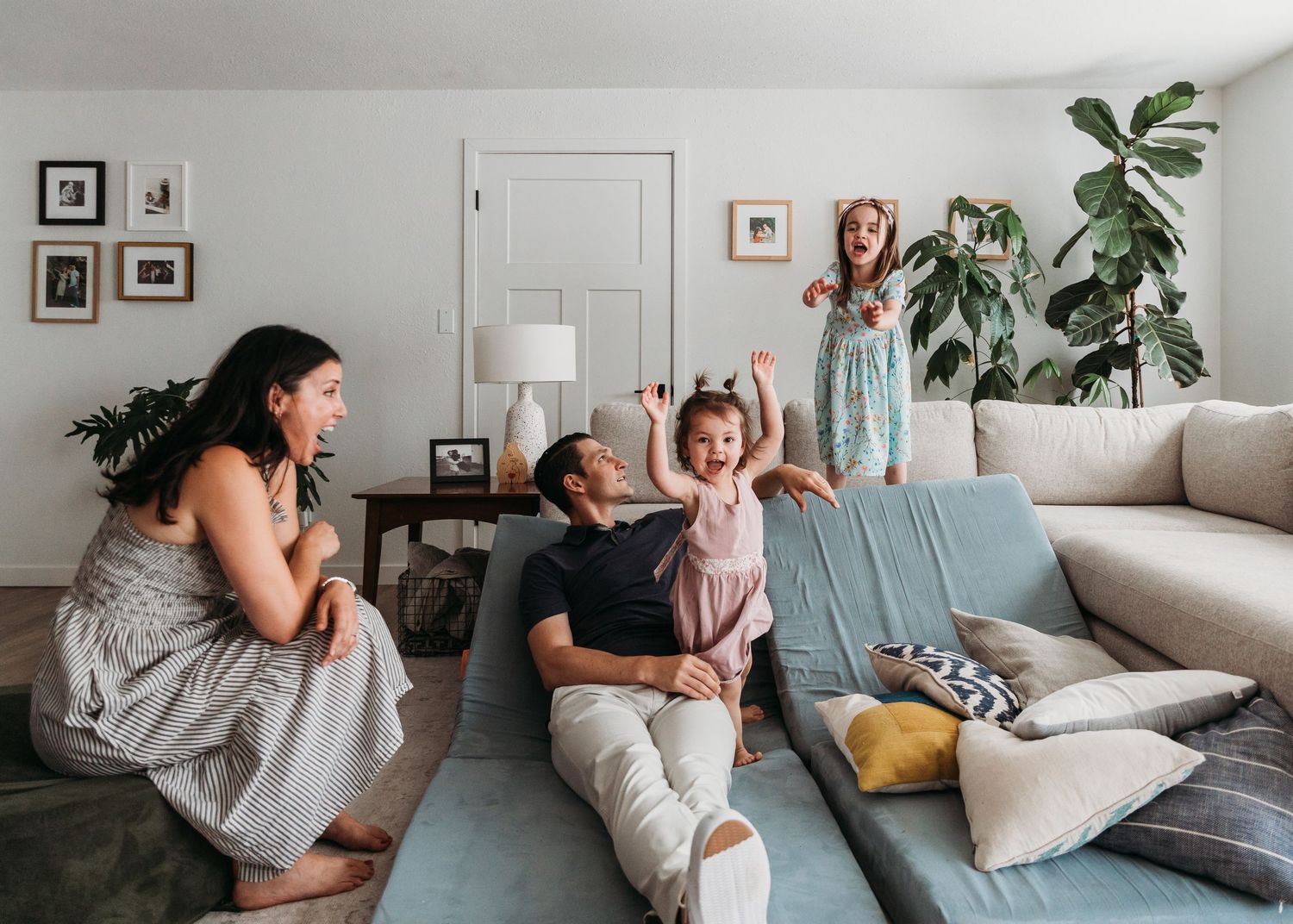 A series of candid lifestyle photos showing tender moments between two people on a couch in a bright living room.