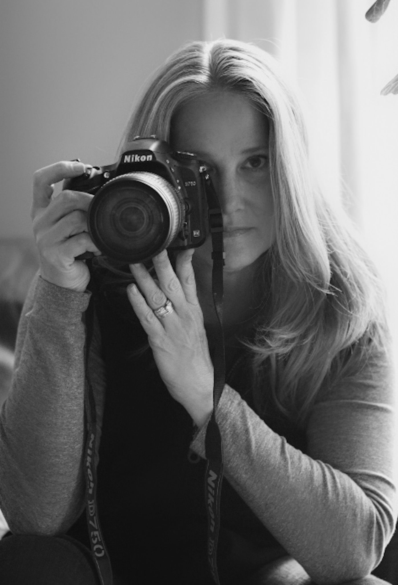 Series of self portraits showing photographer with Nikon camera in black and white.