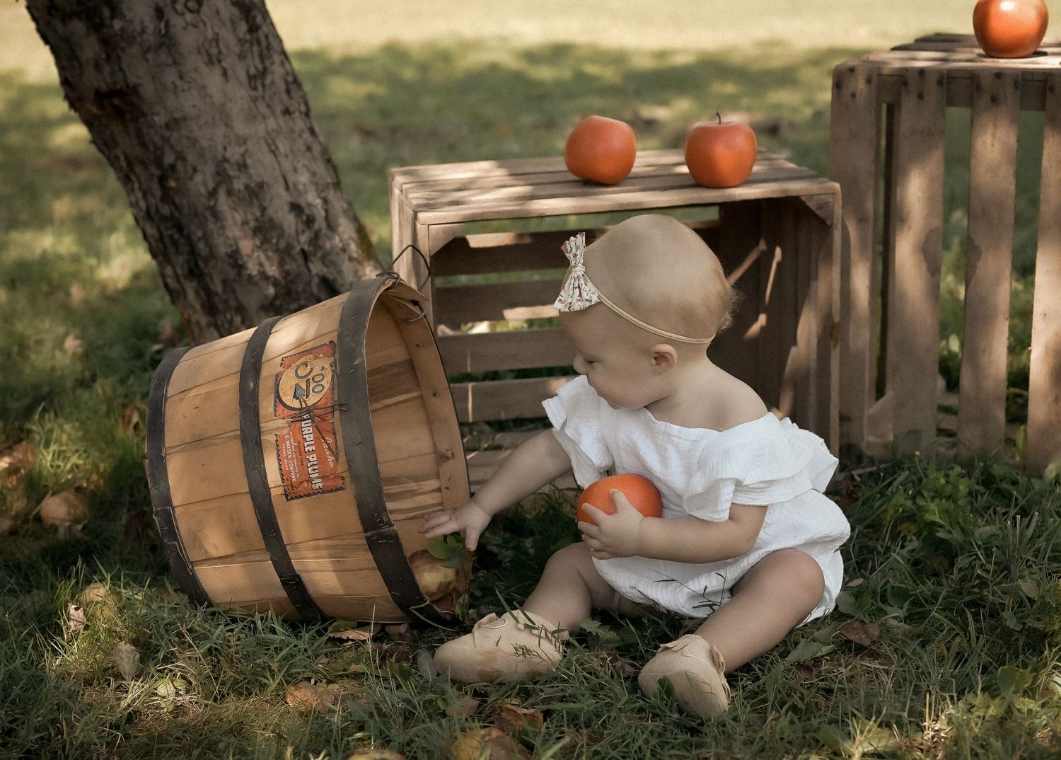 A series of rustic still life photos featuring apples, baskets, and straw hats arranged outdoors in natural lighting.