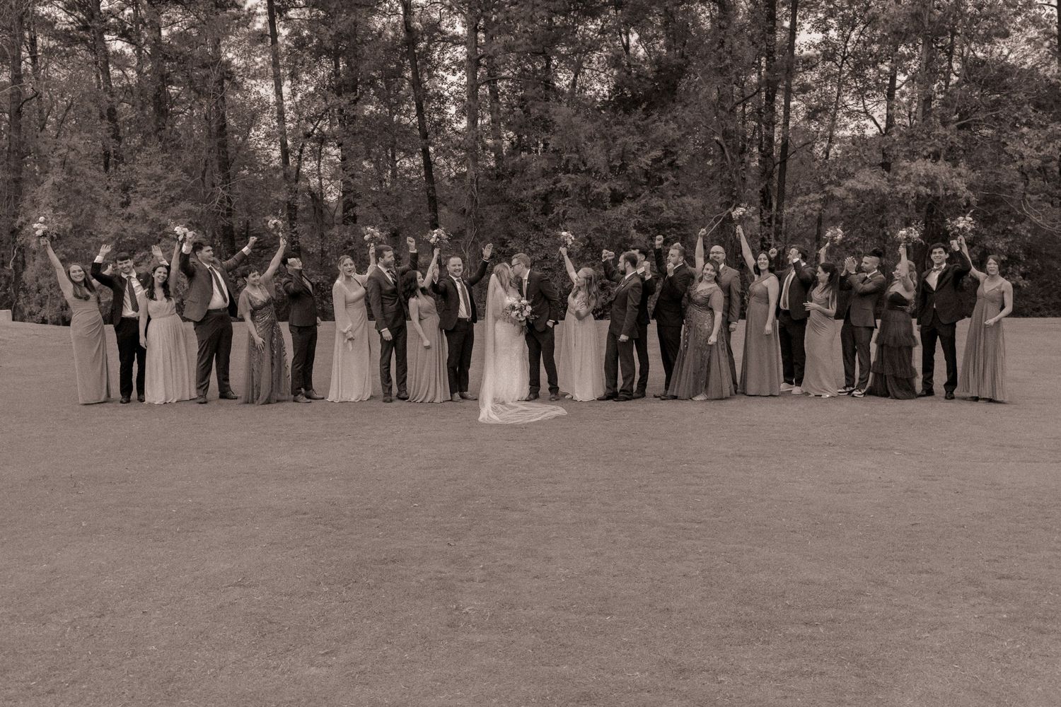 Wedding party celebrating the newlywed couple at Chapel Hill Country Club in Chapel Hill, NC