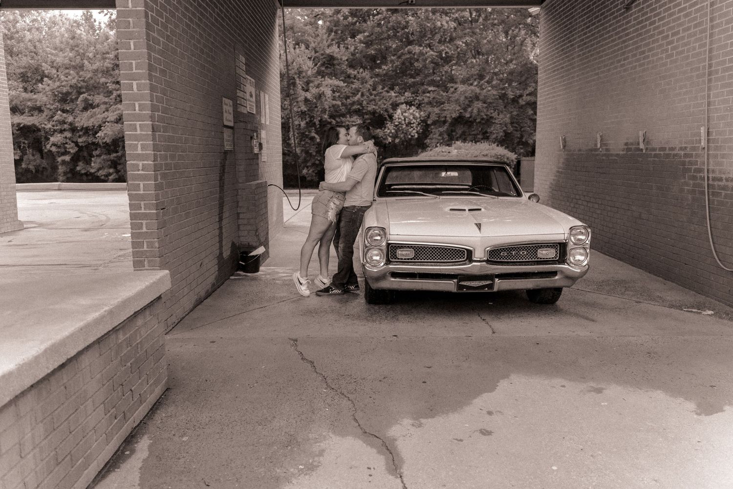 Couple kissing in a car wash in Charlotte, NC