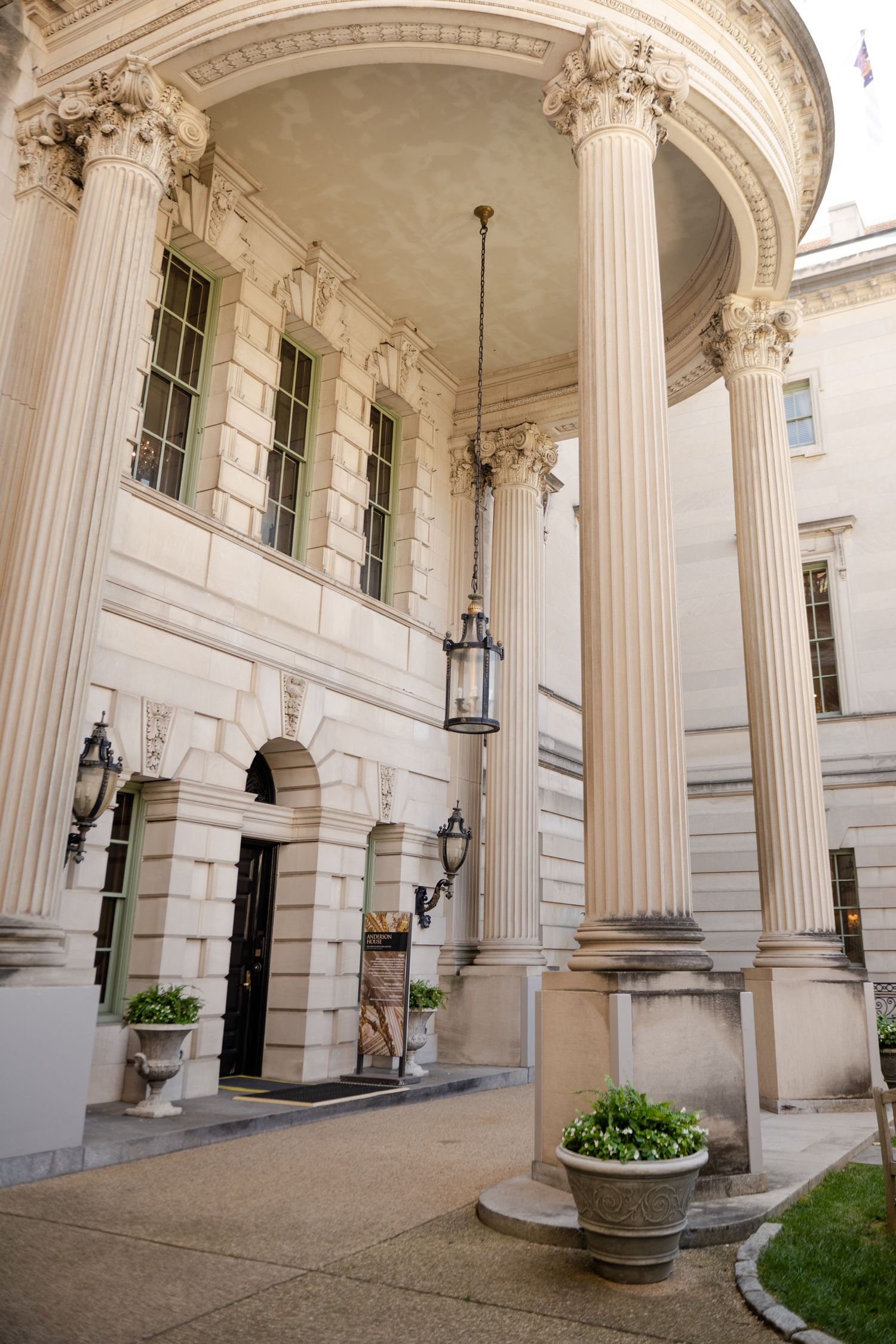 Grand neoclassical entrance with white columns and ornate architectural details at historic venue.