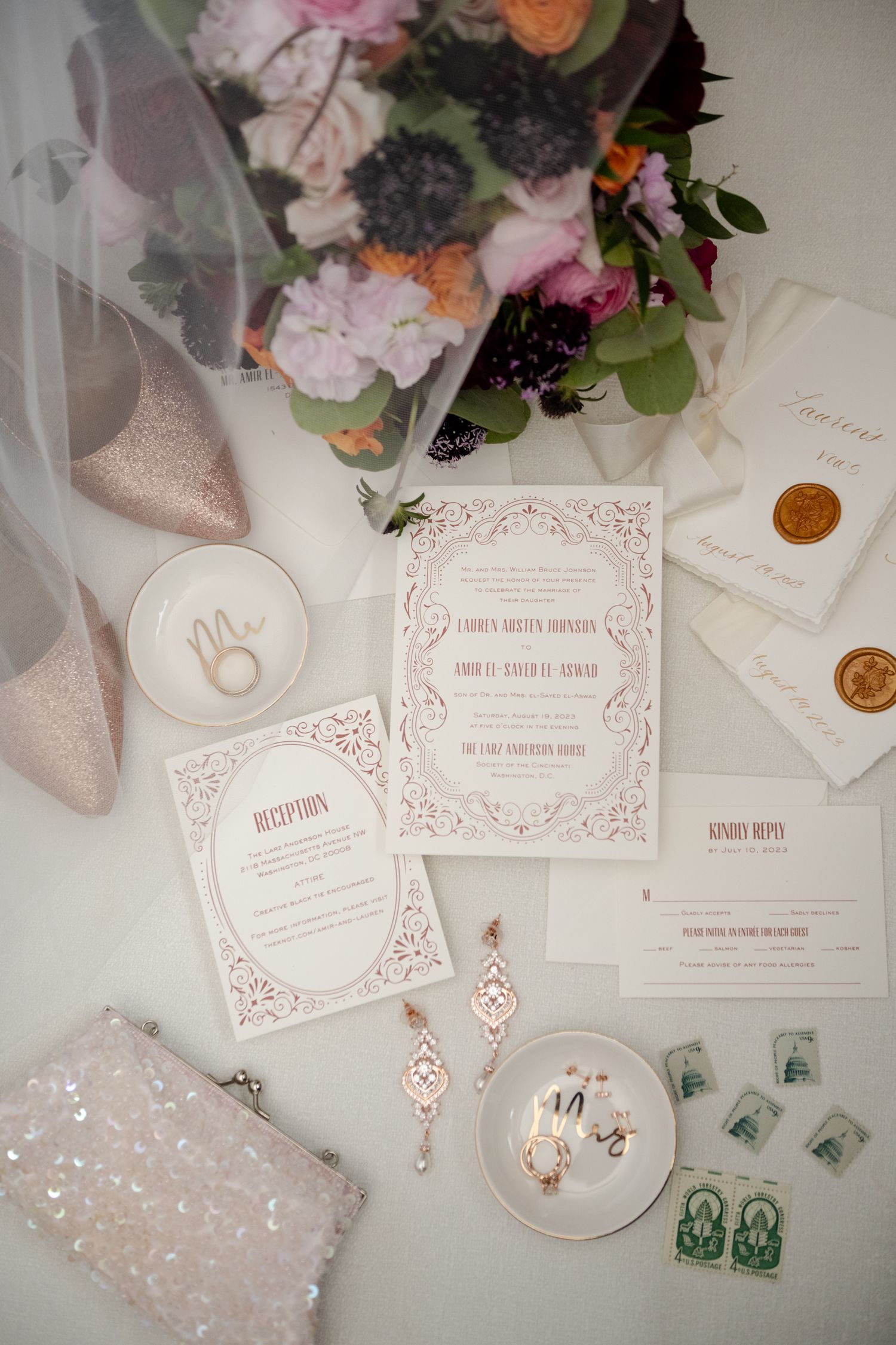 Wedding invitation suite with pink floral design, wax seals, and bridal accessories.