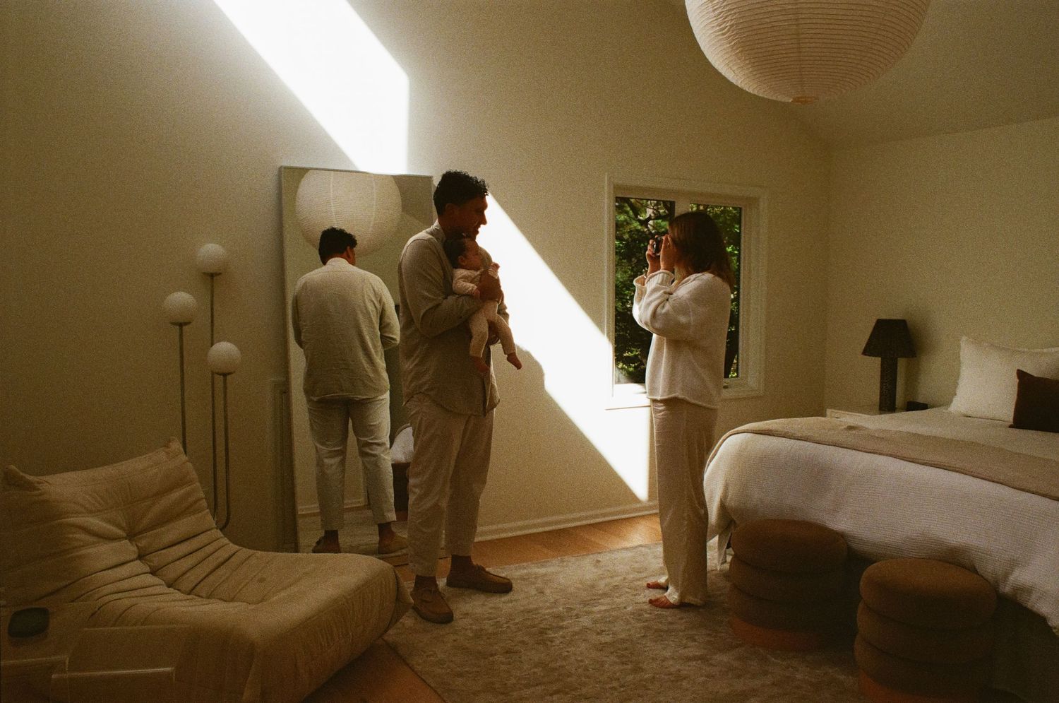 A sequence of photos showing someone sleeping in various positions on a bed under warm lighting.