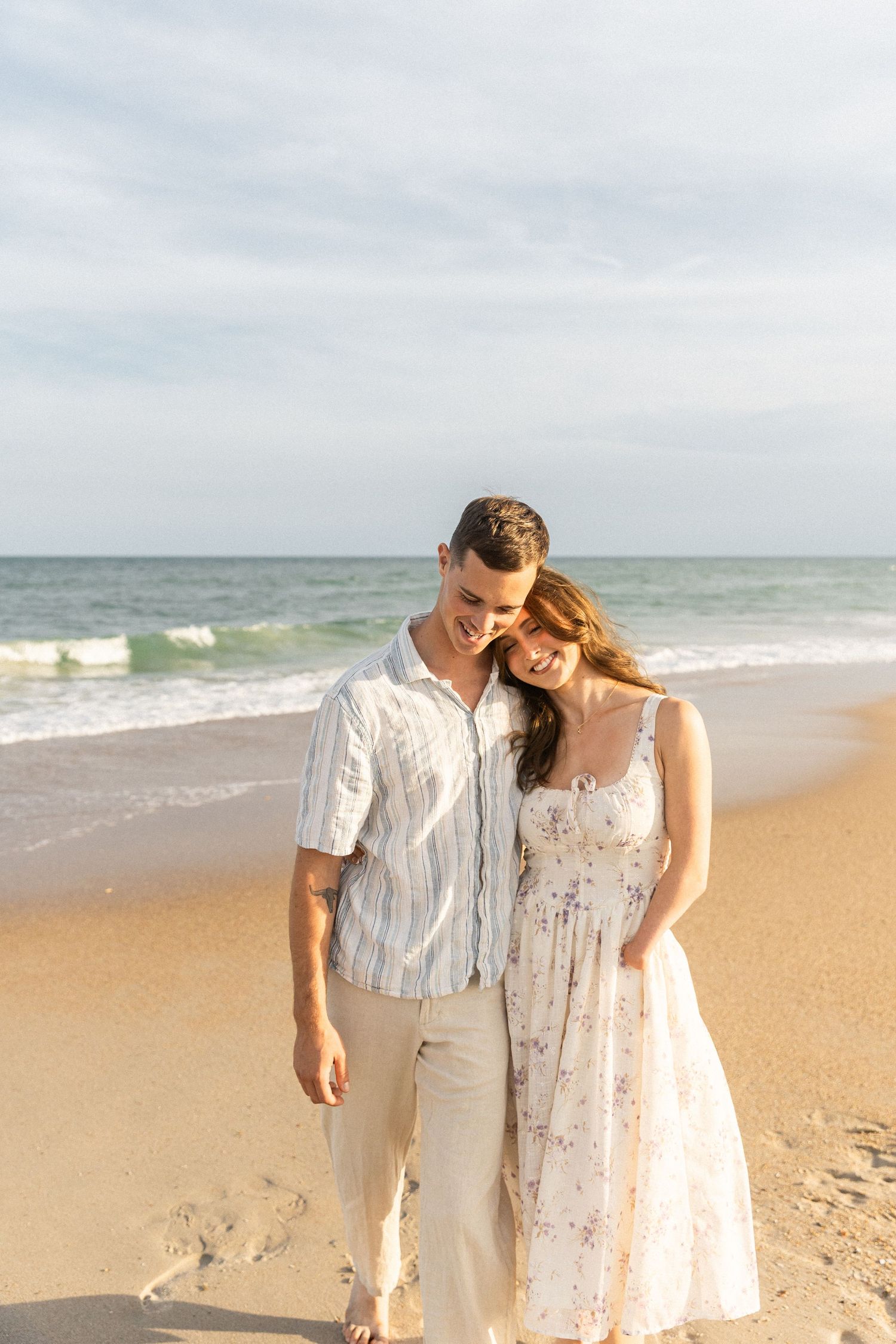 couple walking together on the beach during the couples photos at north topsail beach