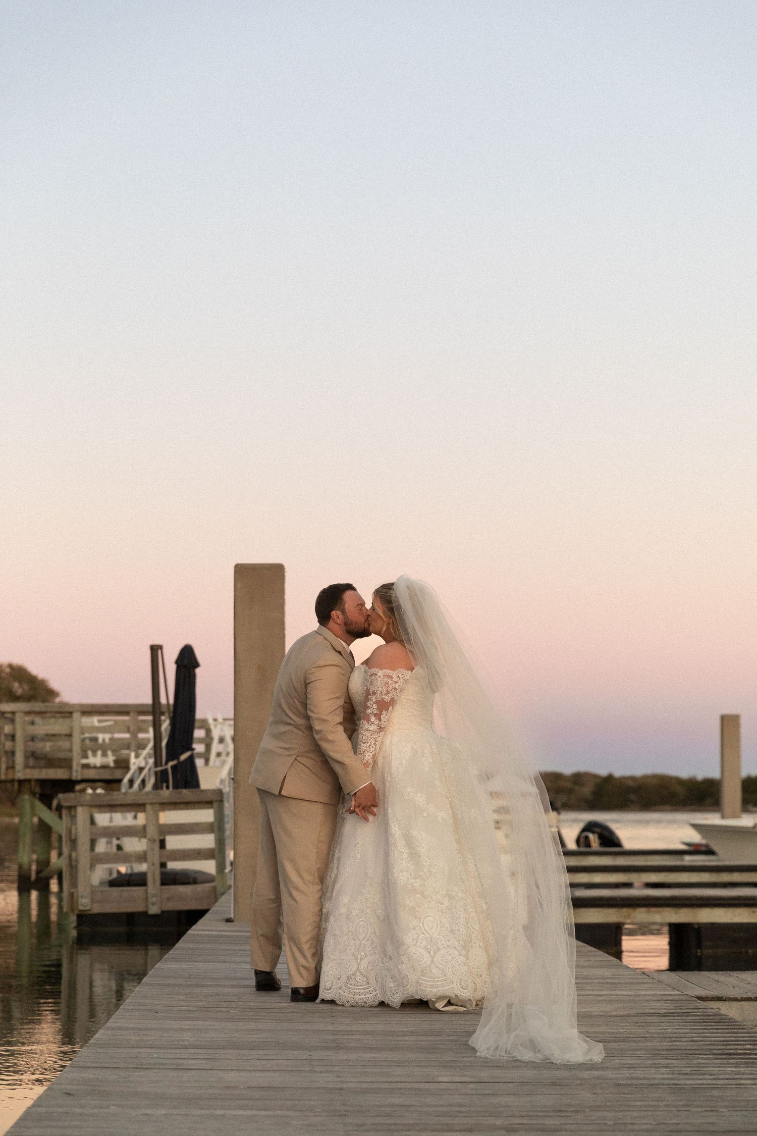 Beaufort North Carolina wedding, couple kissing on dock during the sunset on their wedding