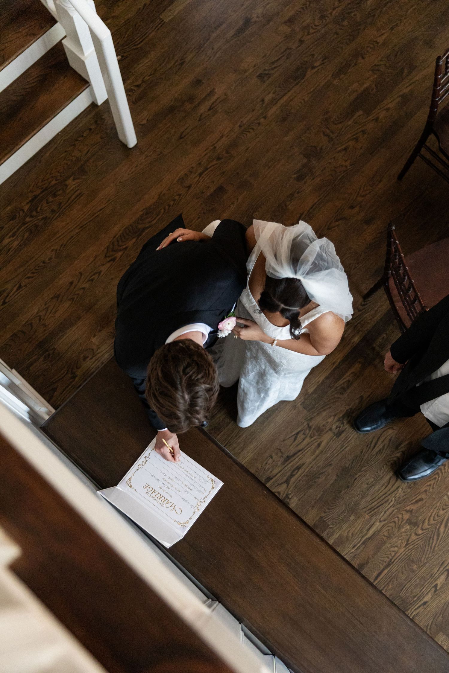 North Carolina Wedding photographer captures the newlyweds signing their marriage certificate