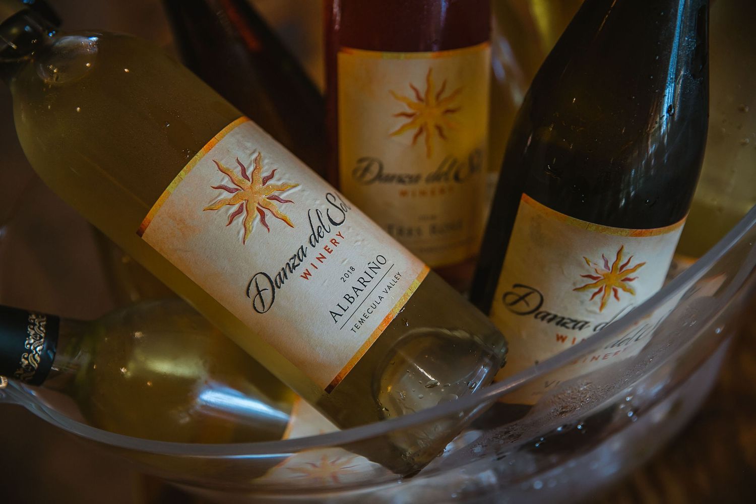 Dunno del Sol Albarino white wine bottles chilling in an ice bucket at a wine tasting event.