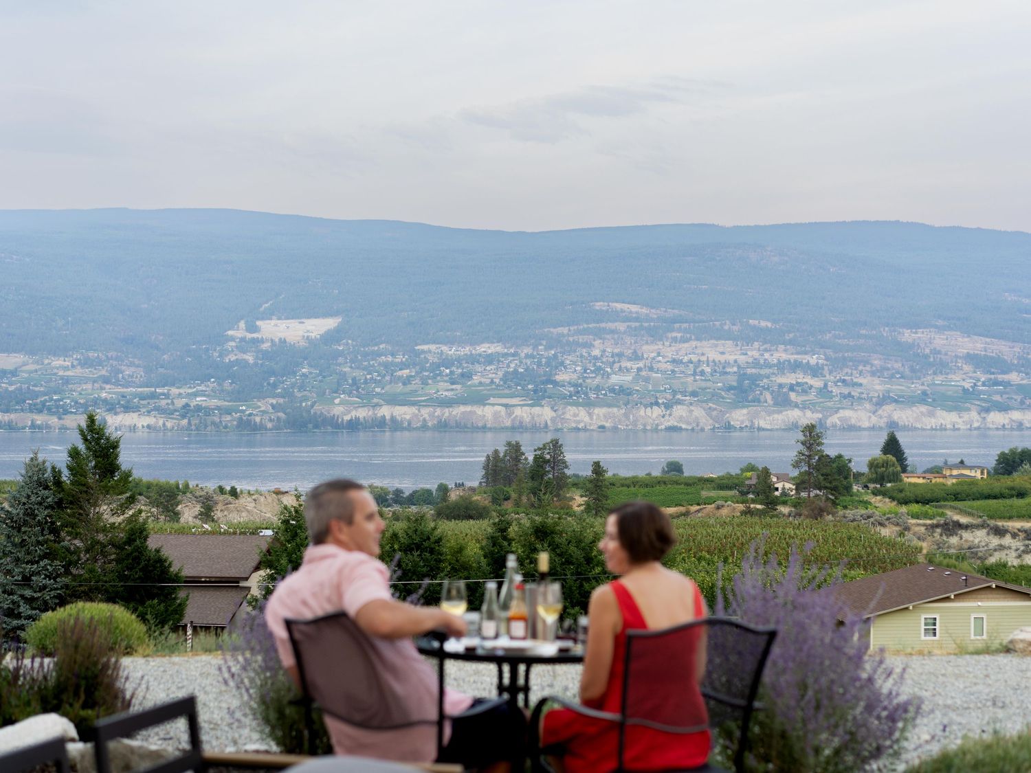 Couple dining outdoors overlooking Okanagan Lake — romantic lifestyle photo by Kelowna photographer James Fujita