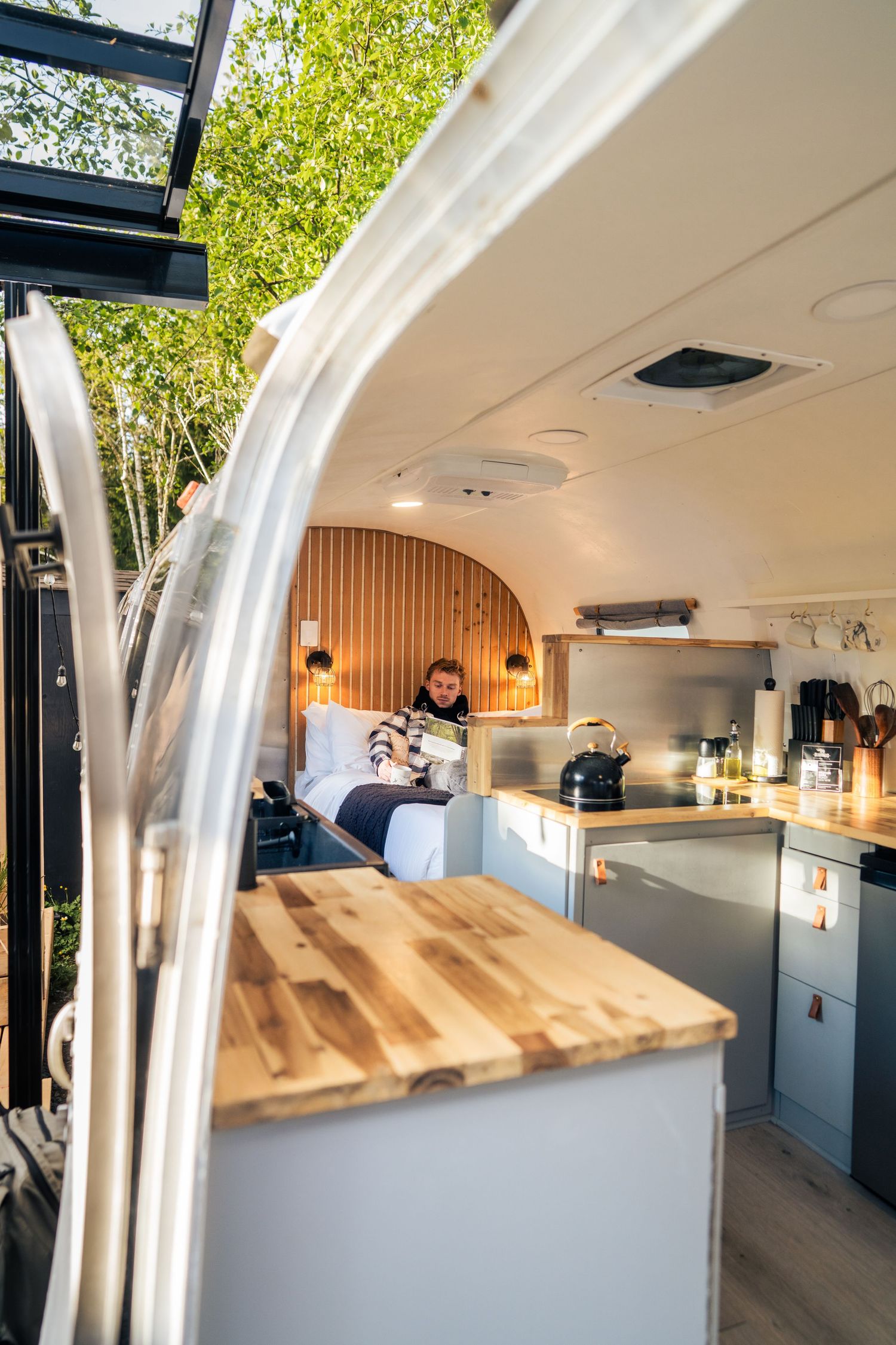 Airstream suite with kitchen and queen bed — glamping and resort content photography by James Fujita in BC.