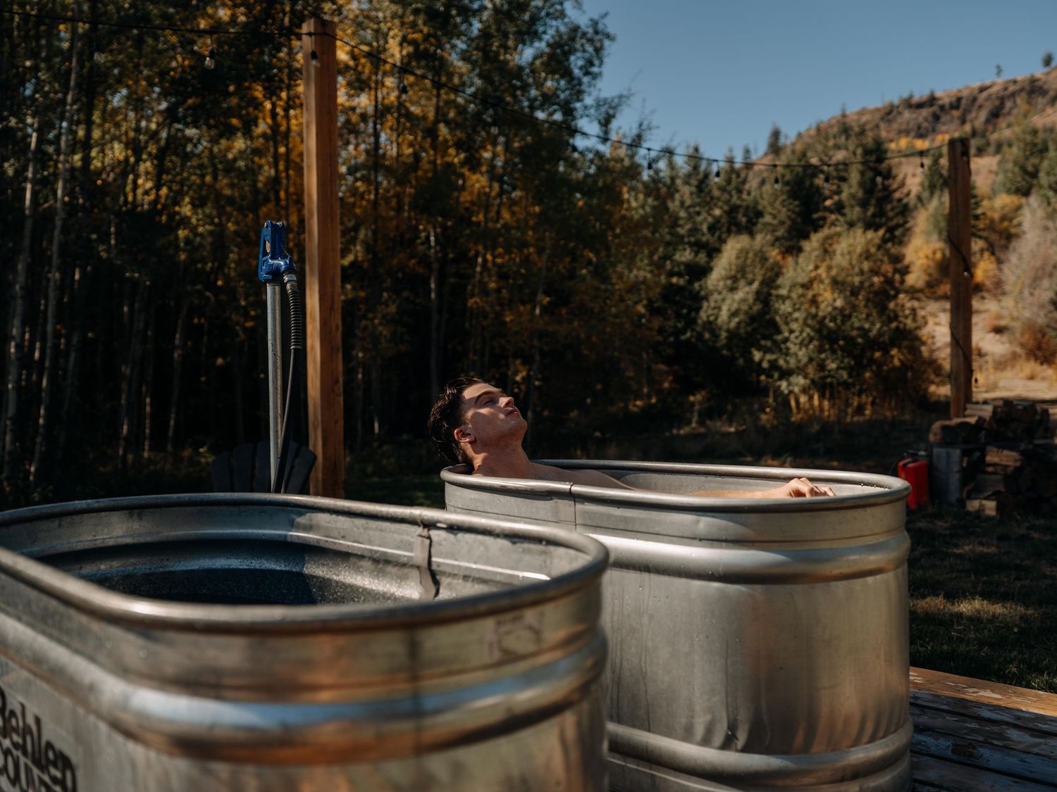 Outdoor cold-plunge tubs under forest sunlight — wellness and resort photography by James Fujita in the Okanagan.