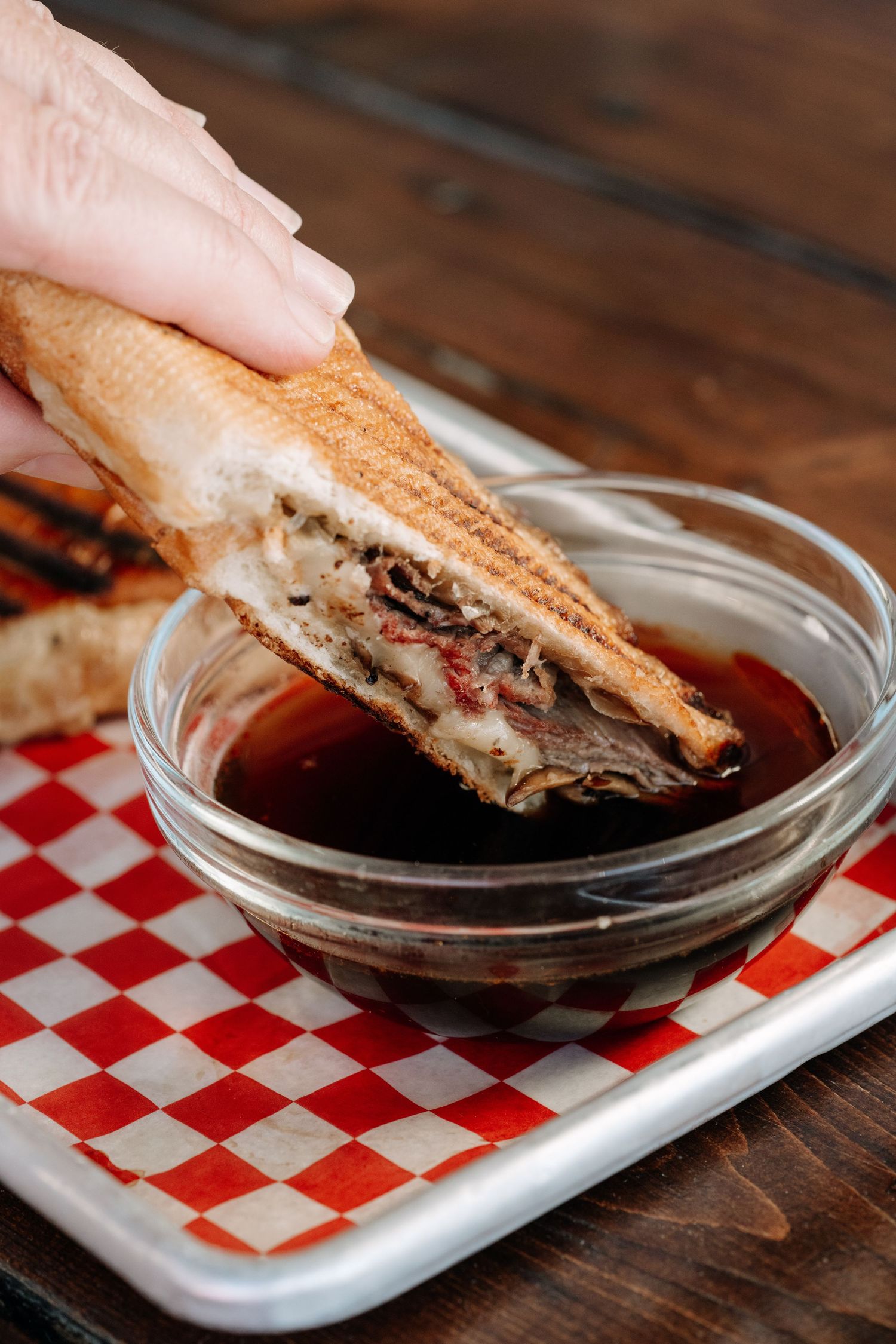 Toasted sandwich dipped in au jus — cinematic brand food photography by James Fujita in British Columbia