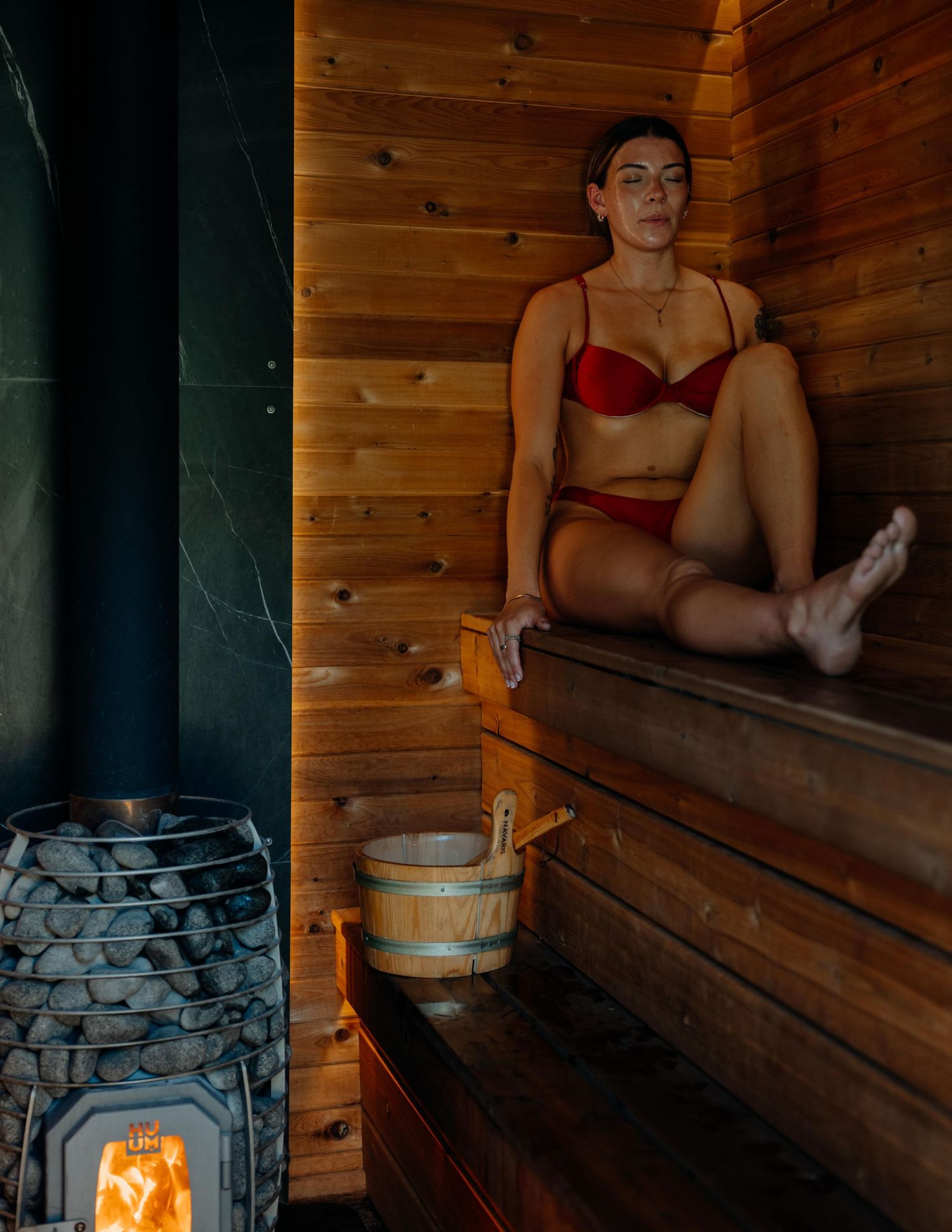 Guest enjoying wooden sauna — resort lifestyle photo by James Fujita for BC hospitality brands.
