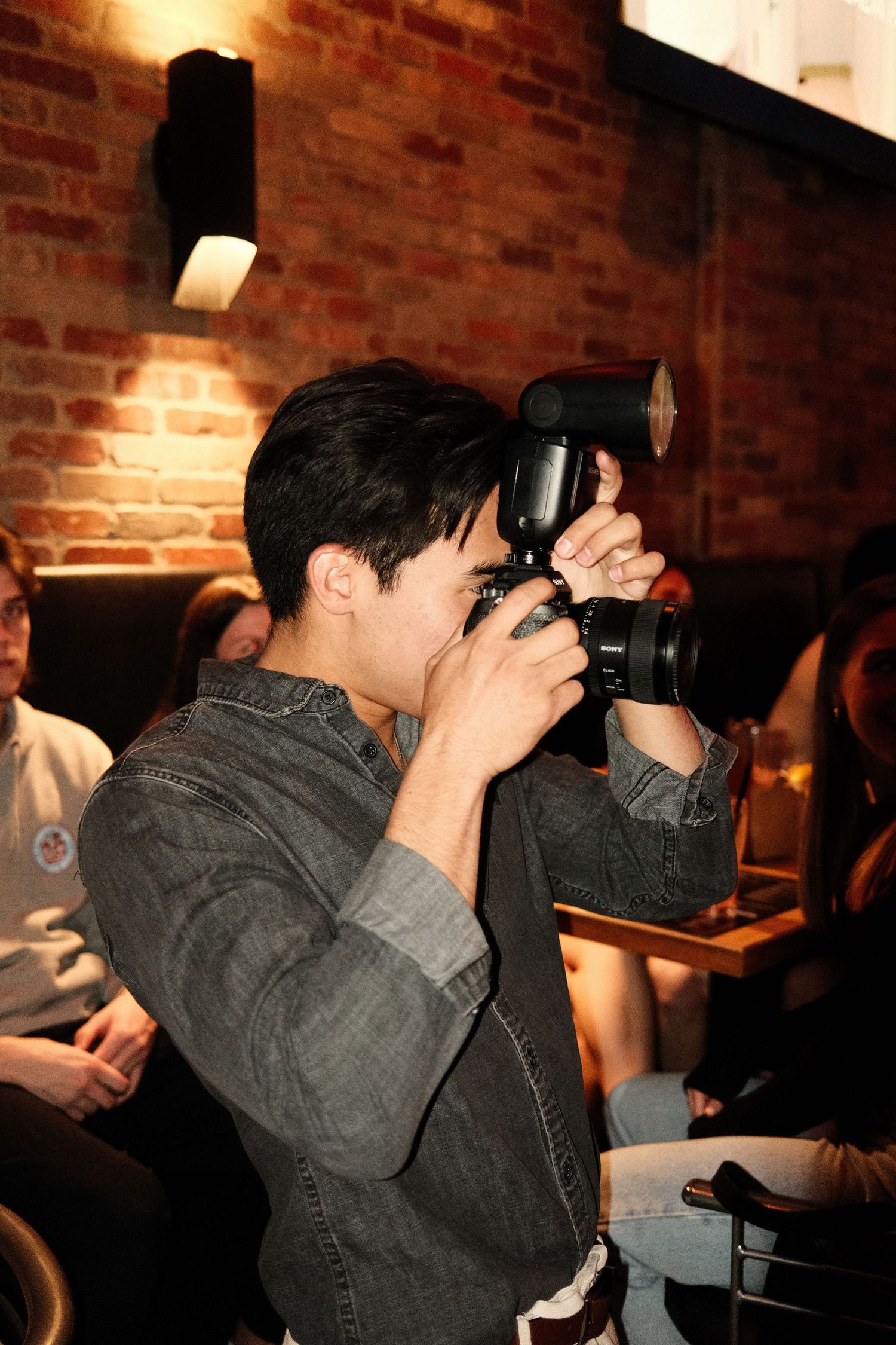 James Fujita photographing an event indoors — professional brand photographer based in Kelowna, BC.