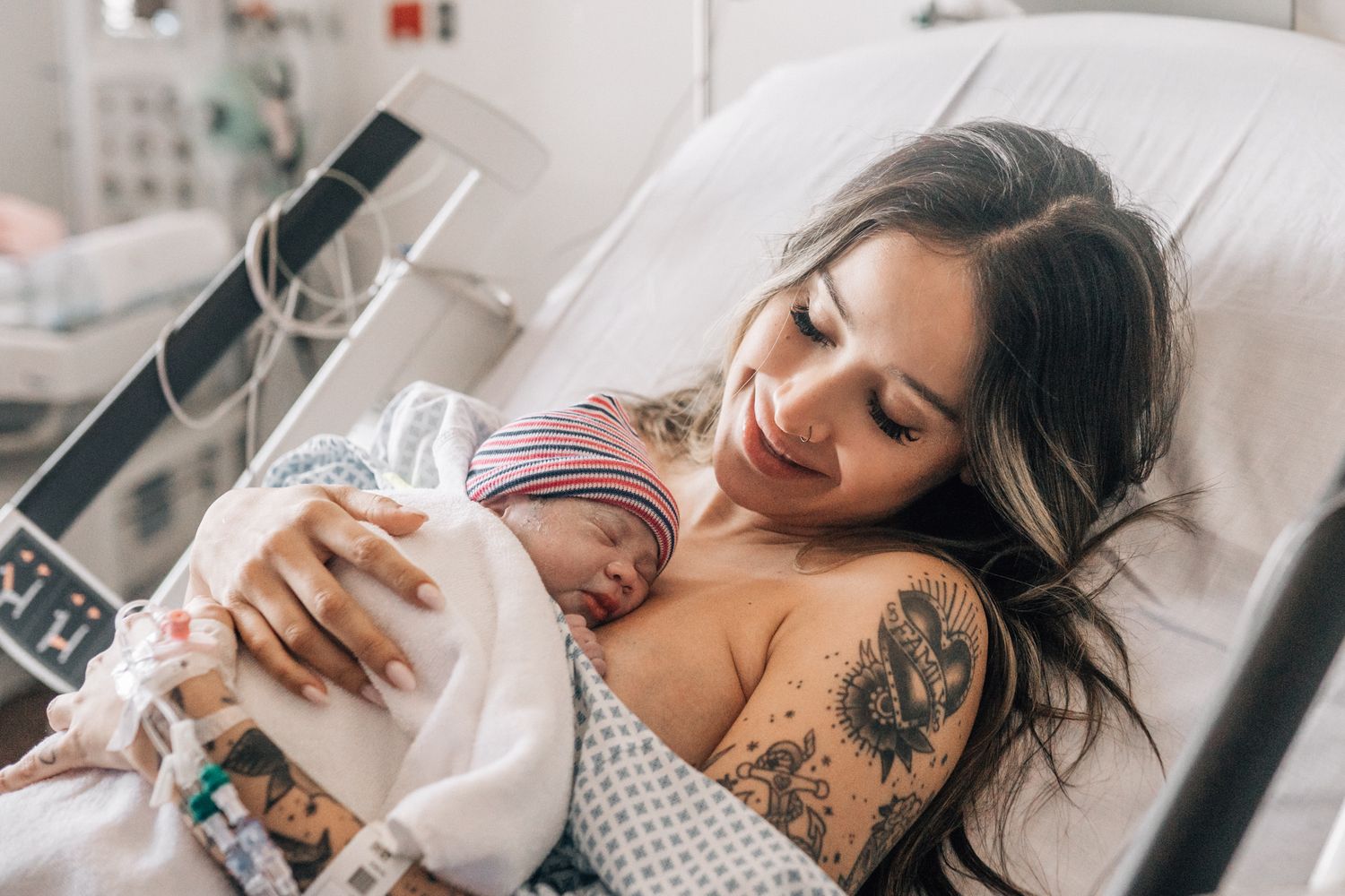 Smiling mother holding and looking at her new baby right after giving birth in dubai