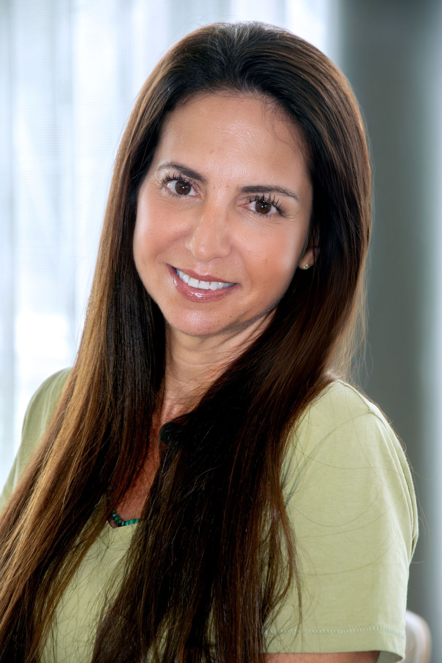 Professional personal branding headshot of a female entrepreneur in a bright, natural setting in Rotterdam.