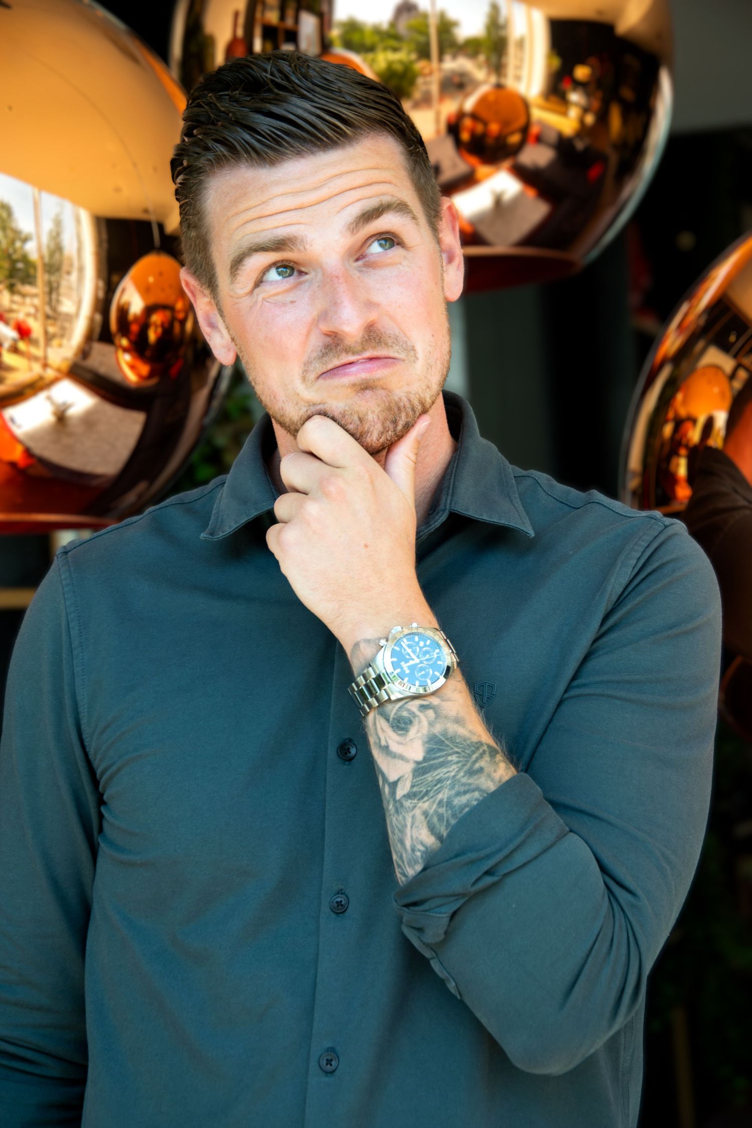 Playful personal branding portrait of a male entrepreneur posing thoughtfully in a creative modern setting in Rotterdam.