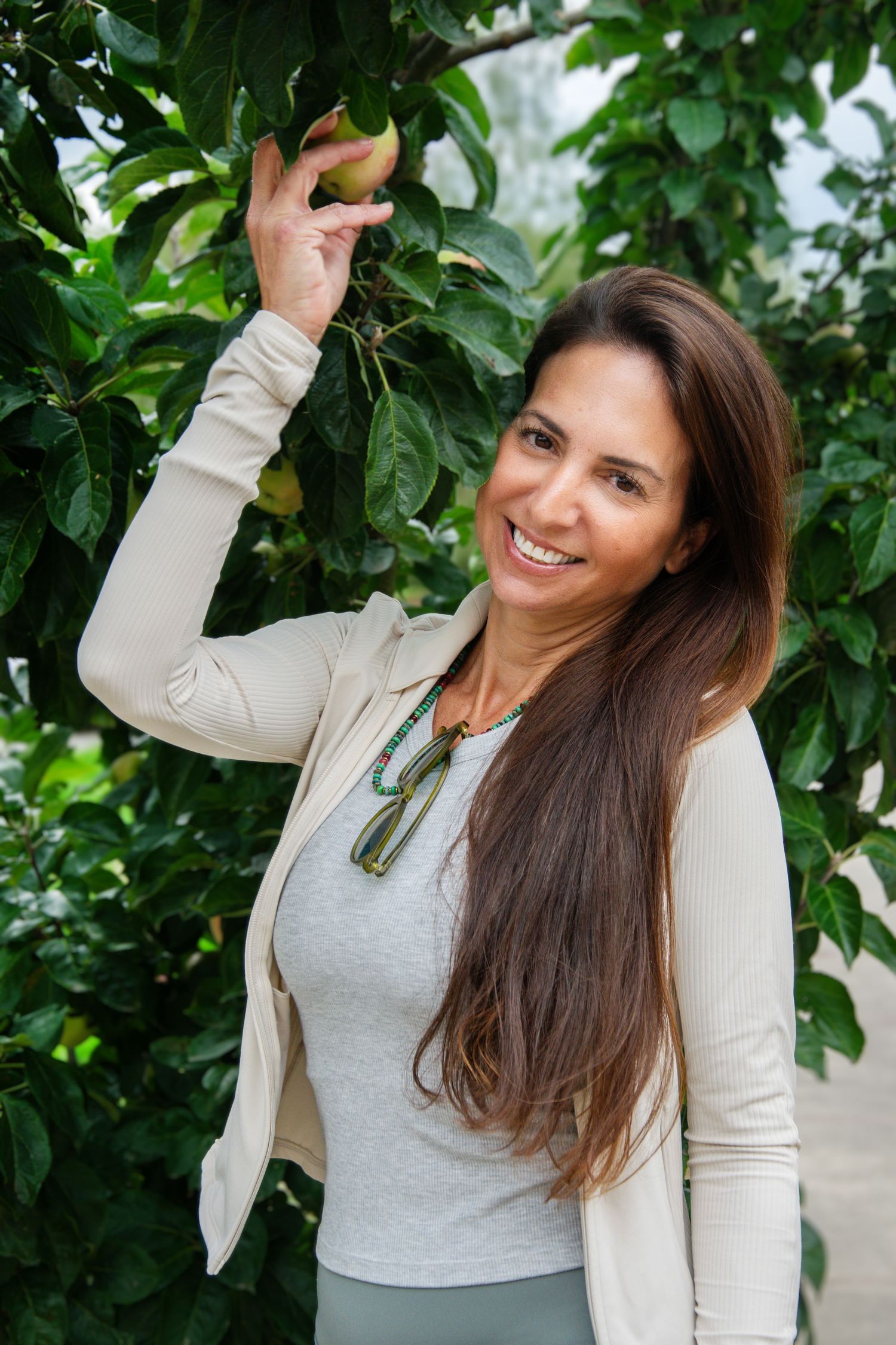 Personal branding portrait of a healthy food entrepreneur surrounded by fresh greenery, photographed in Rotterdam.
