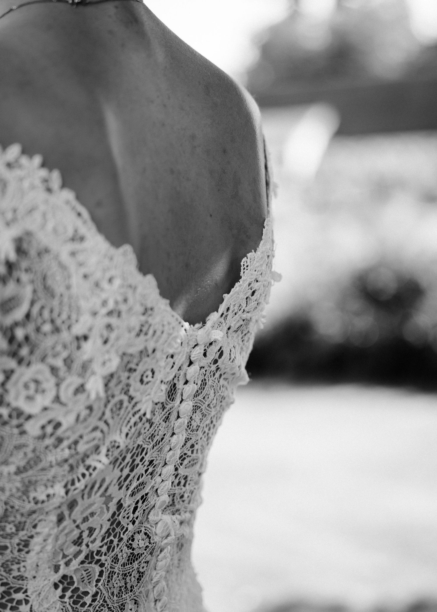 Detailed black and white shot of wedding dress lace bodice.