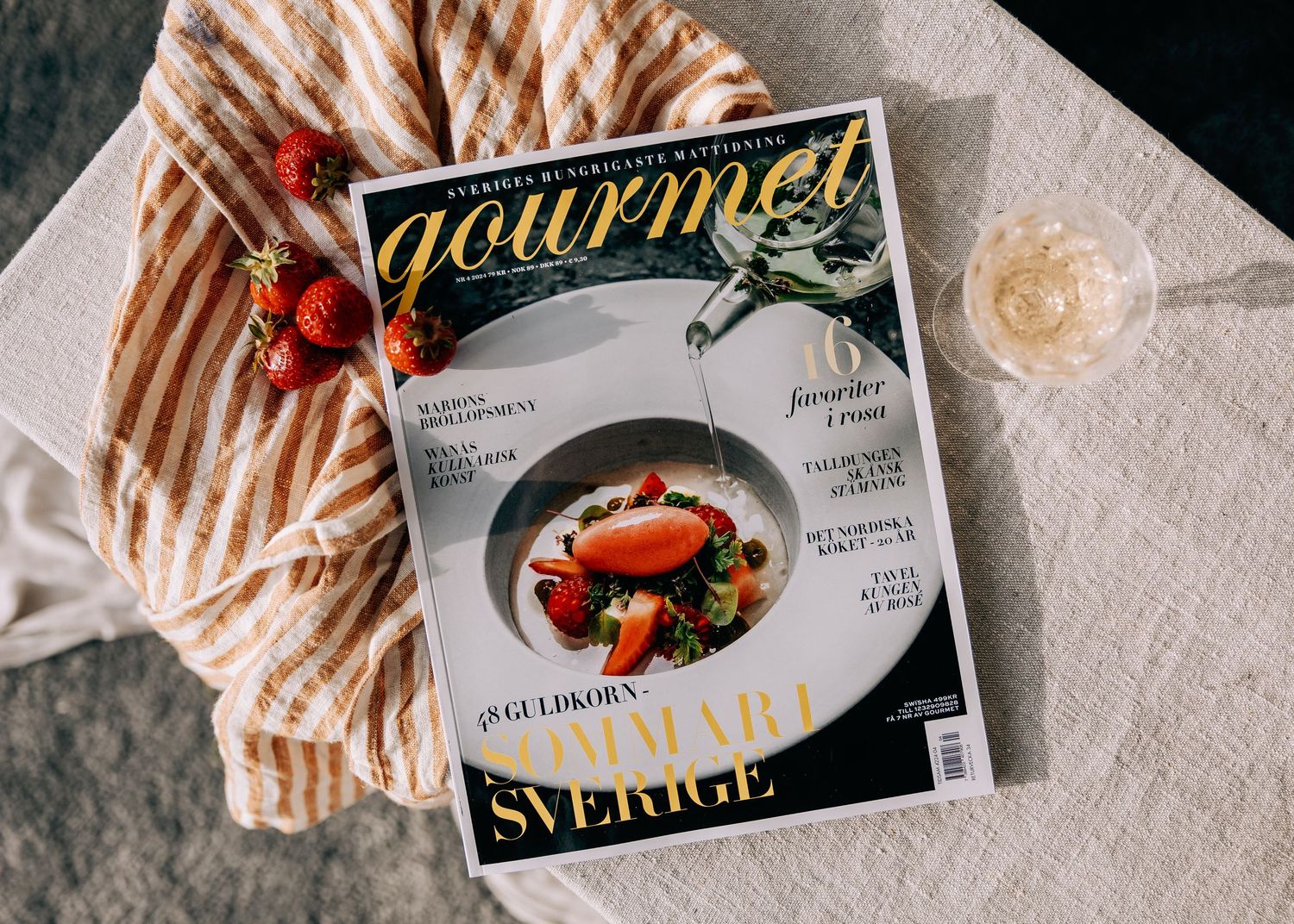 Magazine covers arranged on white textured surface showing food and lifestyle content.