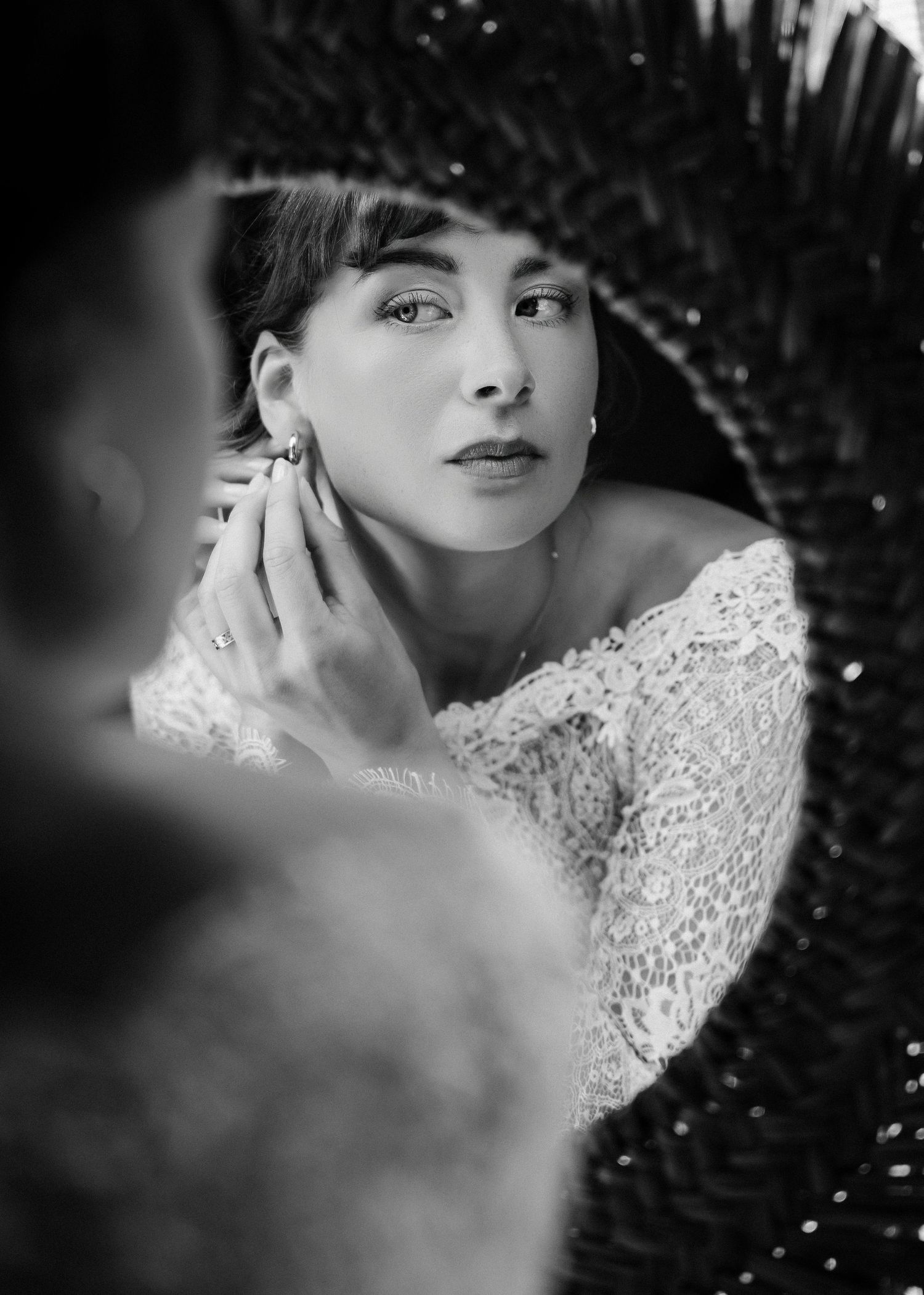 Artistic black and white bridal portrait with lace details.