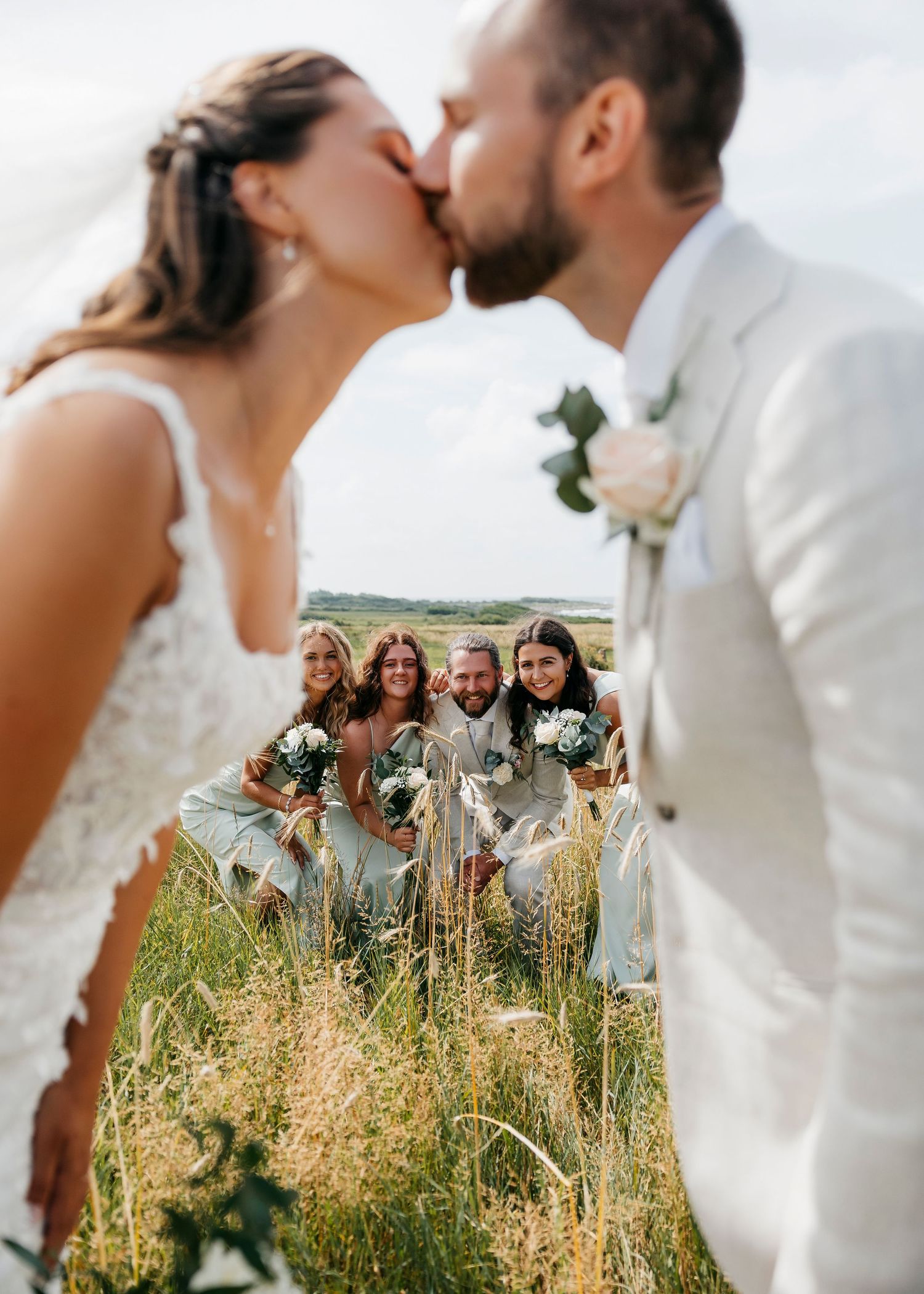 Wedding party portraits alternating between intimate couple shots and group celebrations.